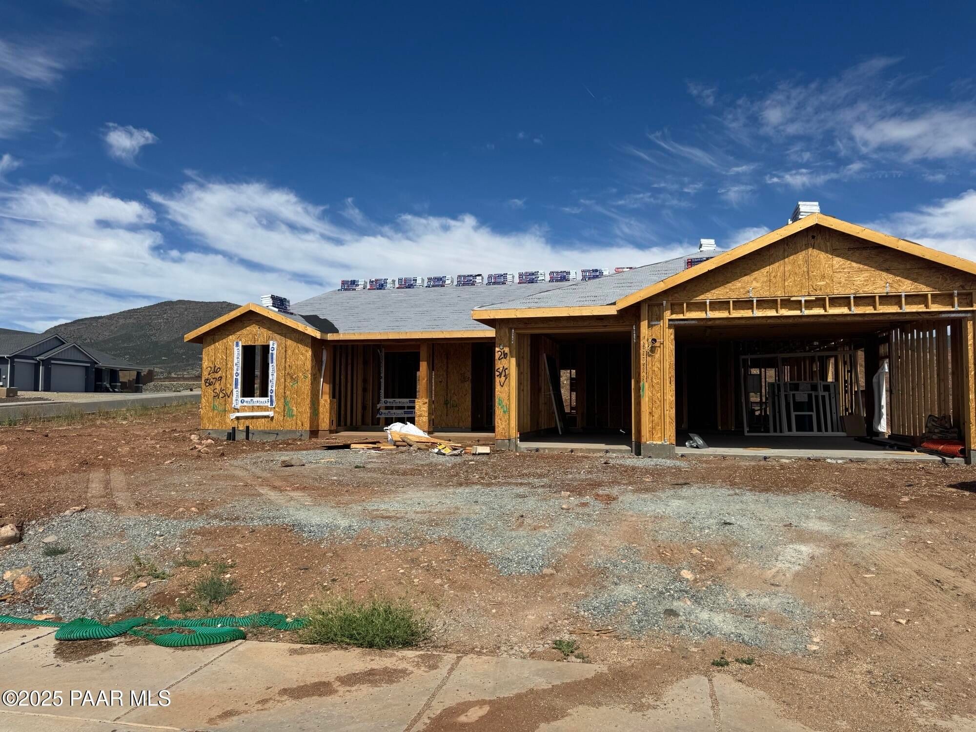 Wooden-framed single-story home with 3-car garage under construction in Morningstar, Prescott Valley, Arizona