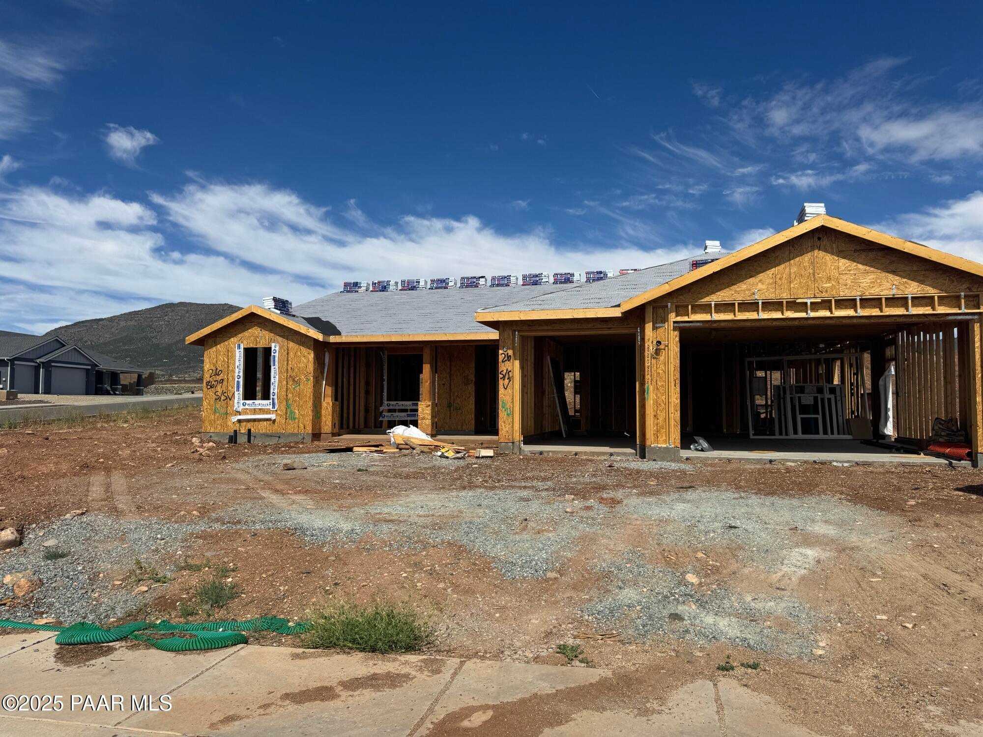 Wooden-framed single-story home with 3-car garage under construction in Morningstar, Prescott Valley, Arizona