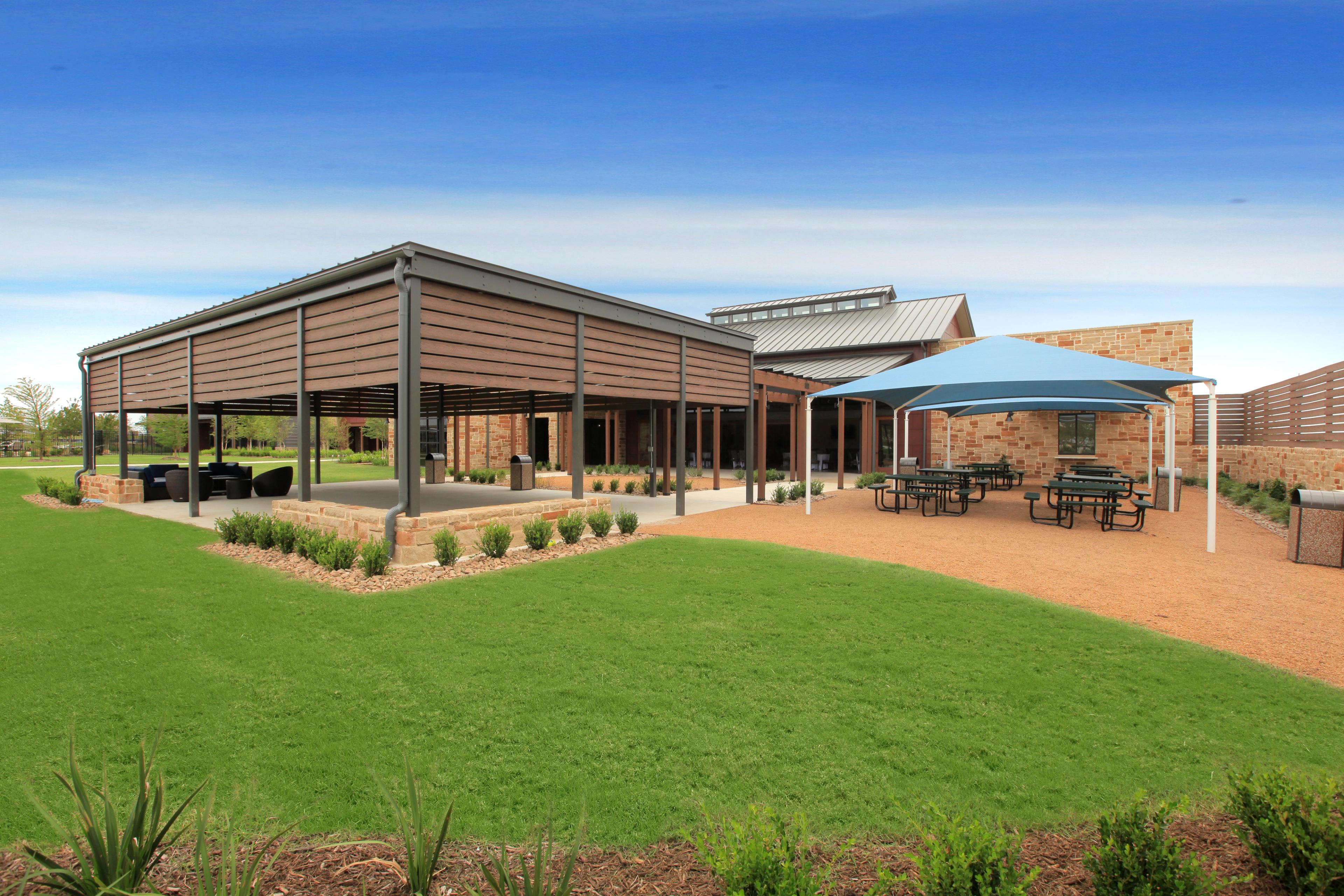Outdoor gathering spaces with tables, chairs and shade structures