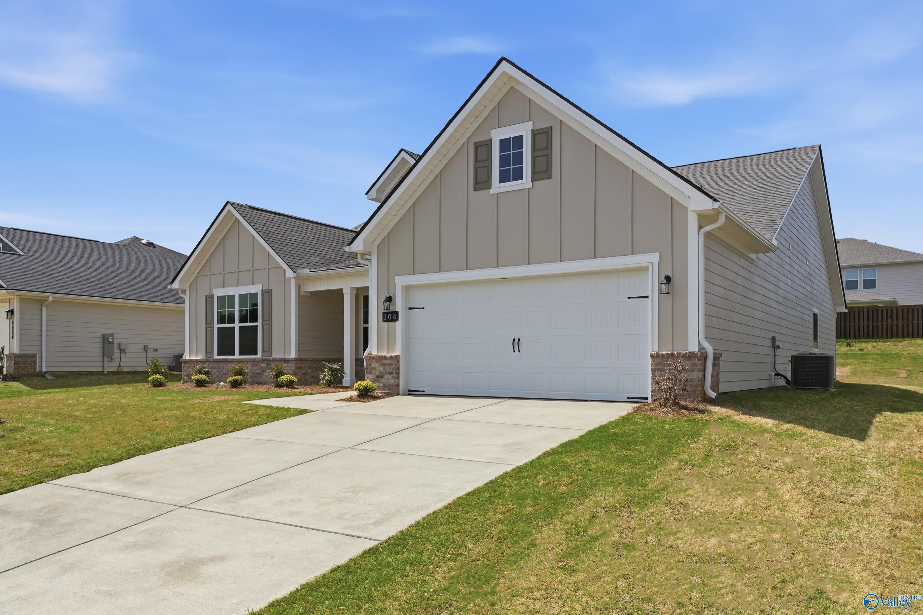 Modern tan-sided single-story home with 2-car garage, driveway, and landscaping in Evergreen Mill, Madison, Alabama - Davidson Homes The Rockford C