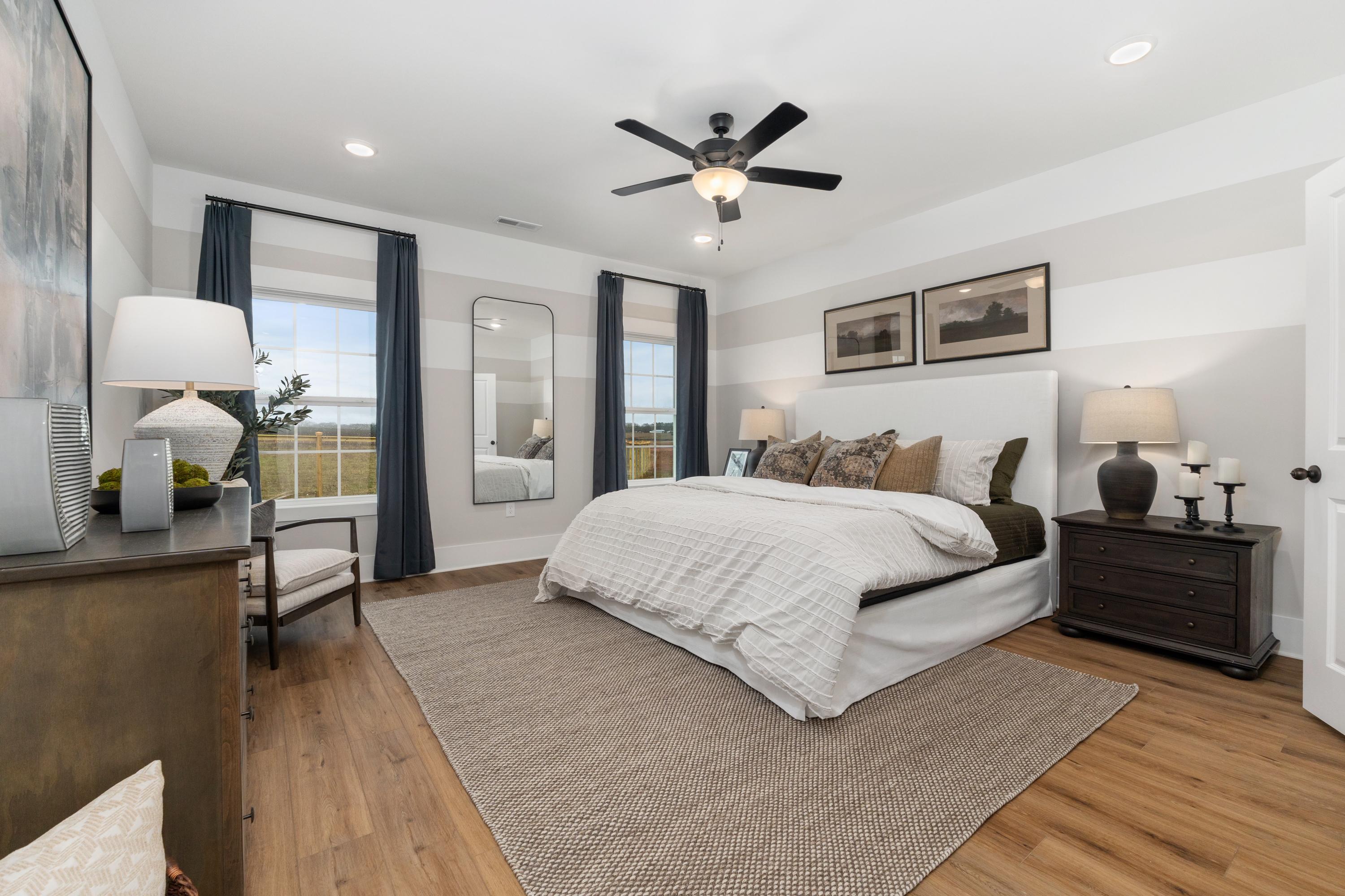 Spacious master bedroom at Little Creek in Arab Alabama with king bed, hardwood floors, ceiling fan, and neutral decor