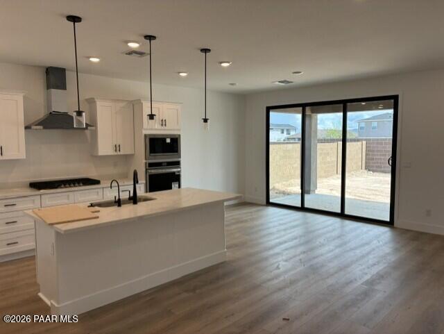 White kitchen island with pendant lights and sliding glass doors in Davidson Homes Durango II G, Prescott, Arizona new home