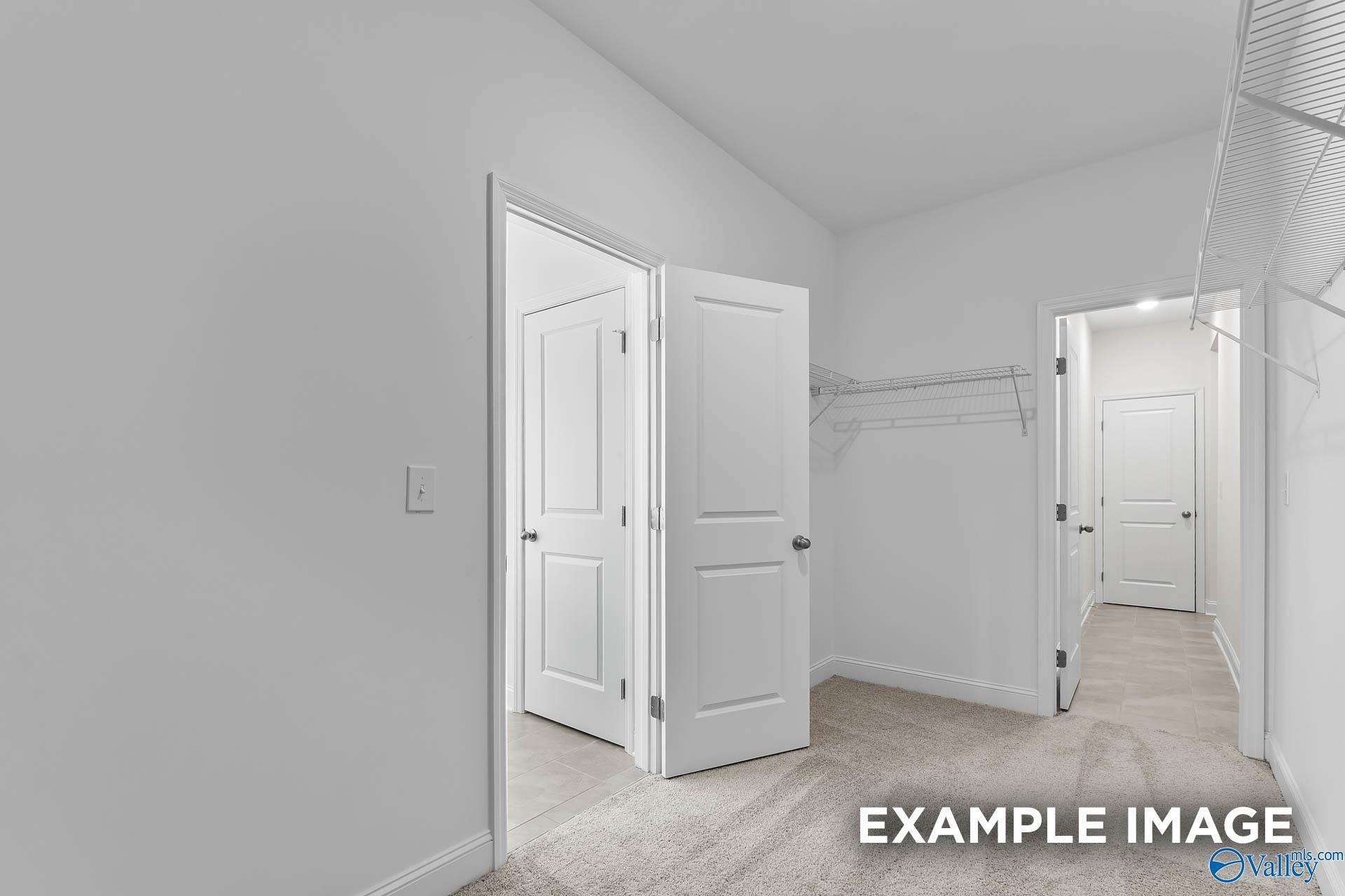 Spacious walk-in closet with wire shelving in master suite of Davidson Homes The Harrison C, Anderson Farm, Athens, Alabama