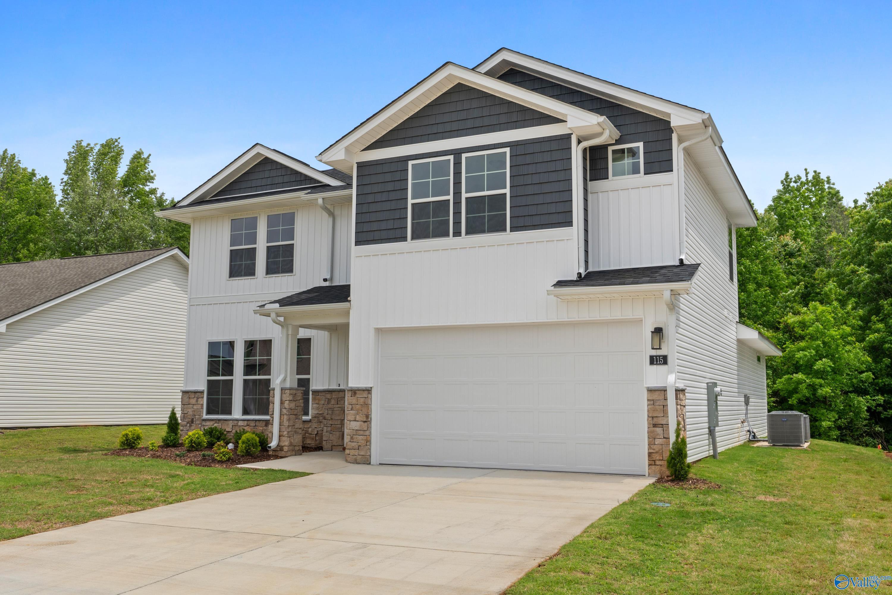 Modern 2-story The Stella home by Davidson Homes in Forest Glen, Hazel Green, Alabama, with white-gray siding, 2-car garage, and driveway