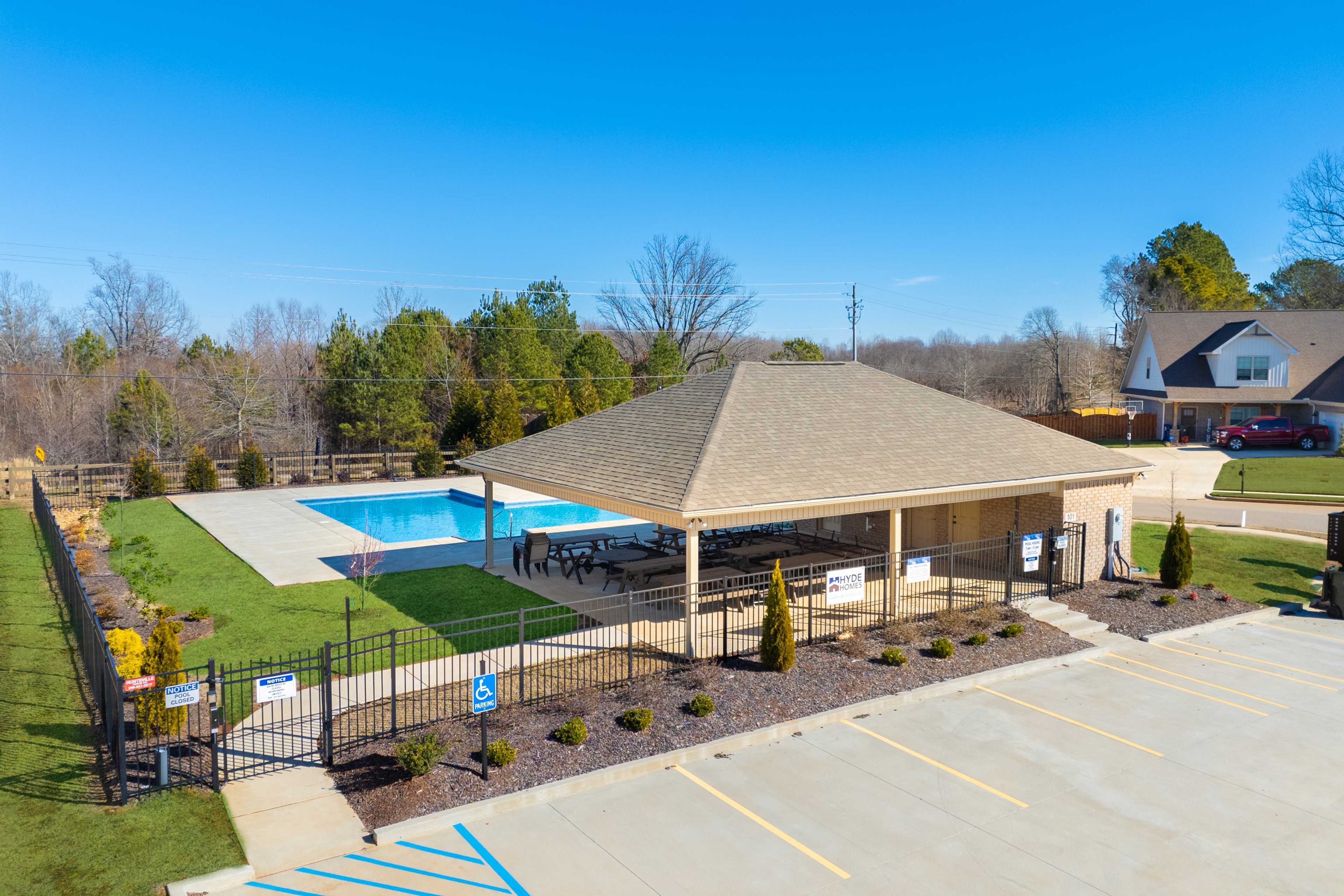 Resort-style swimming pool at Ivy Hills in Toney Alabama with covered pavilion, lounge seating, fencing, and landscaped grounds