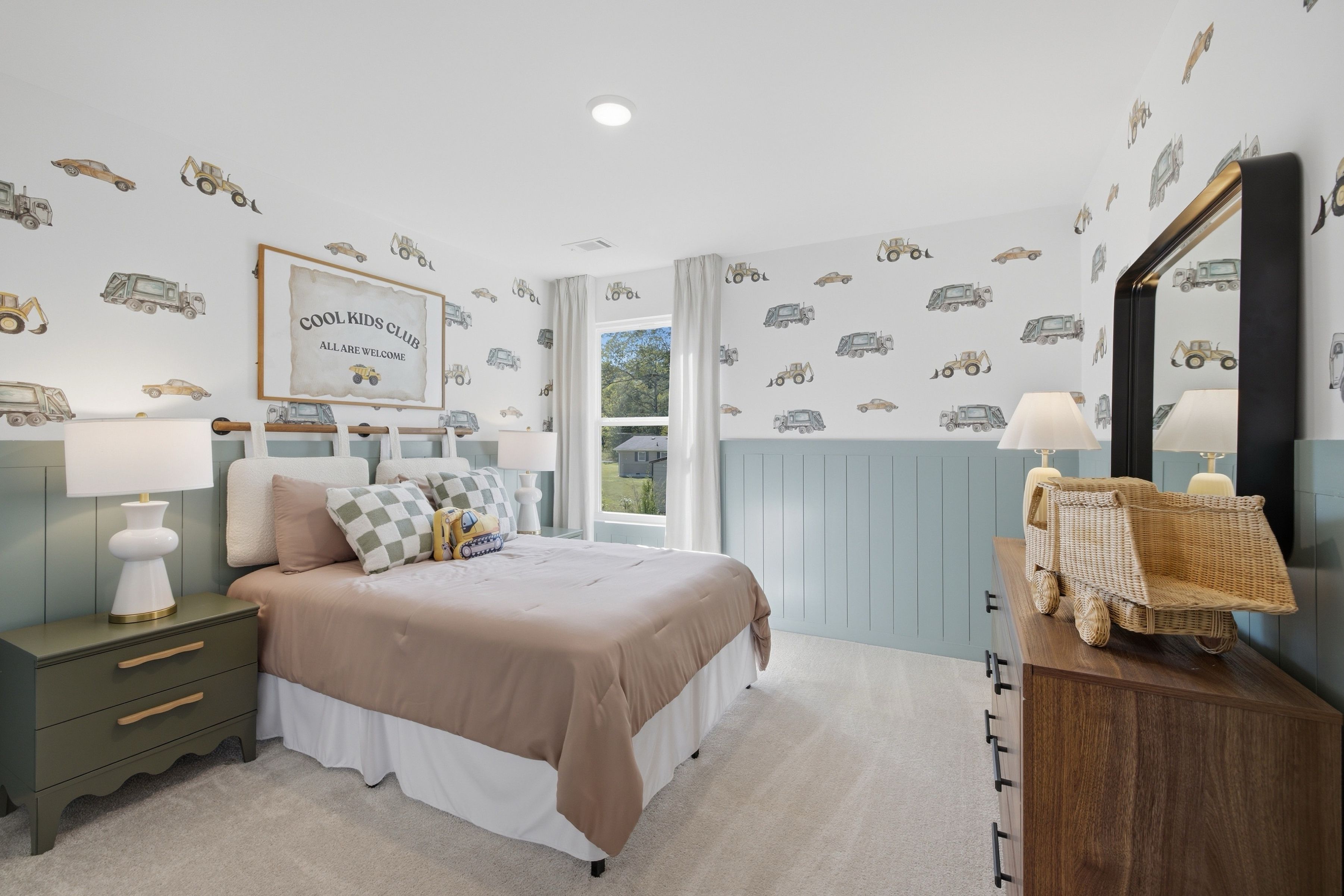Kids bedroom with construction truck wallpaper and green wainscoting at Greene Farm by Davidson Homes in Cartersville, GA