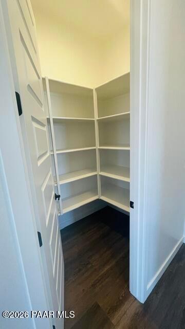 Walk-in pantry with white wrap-around shelving in The Aurea C floor plan at Hidden Hills in Prescott, Arizona.