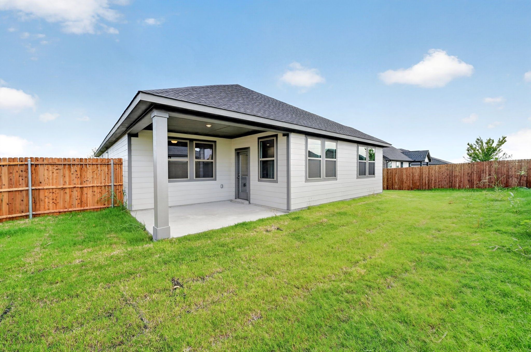 Covered patio and fenced backyard of Davidson Homes The Holly F, 4-bedroom single-story home in Meadow Ridge Estates, Josephine, Texas