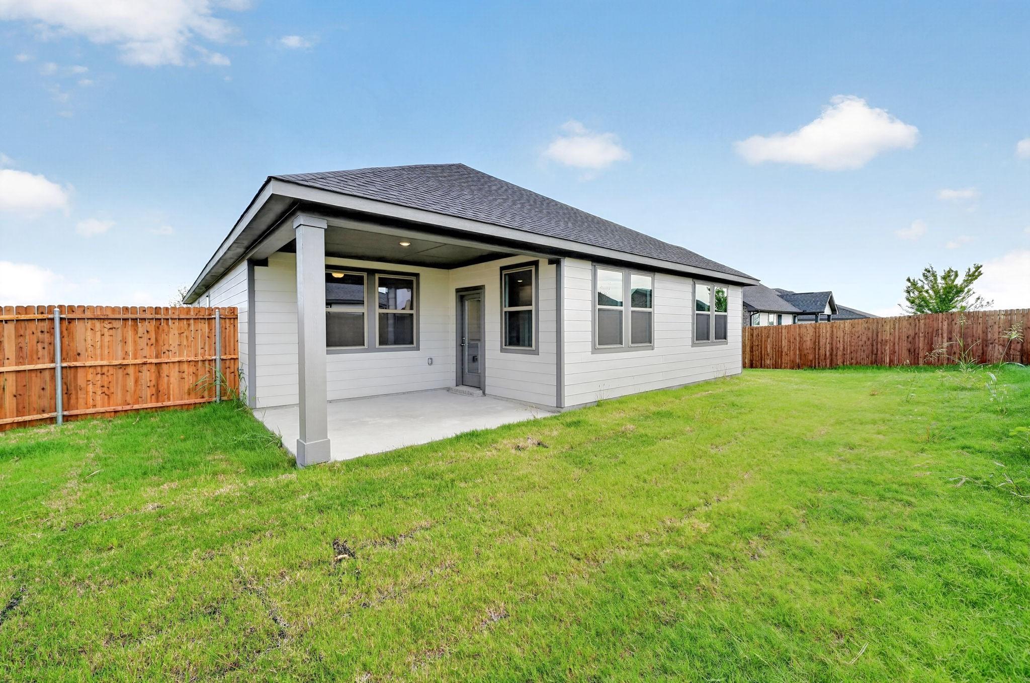Covered patio and fenced backyard of Davidson Homes The Holly F, 4-bedroom single-story home in Meadow Ridge Estates, Josephine, Texas