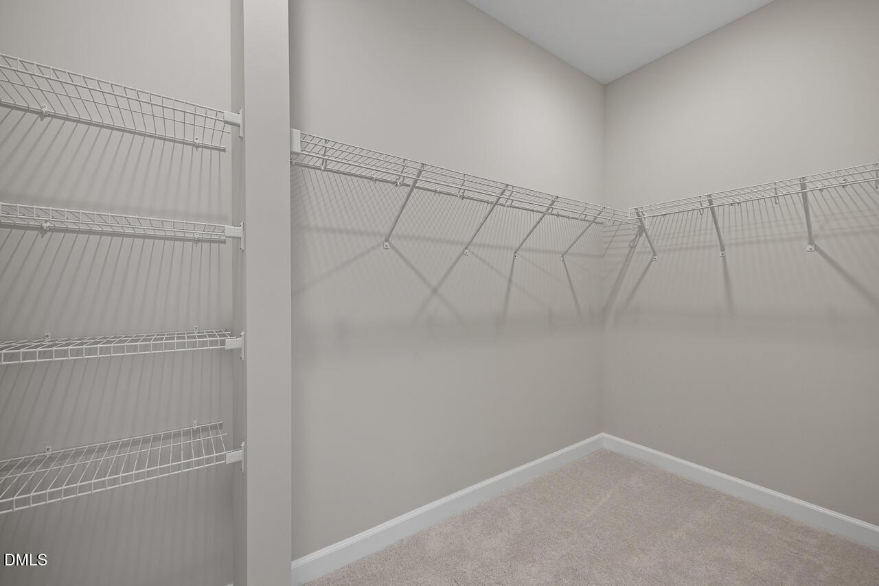 Walk-in closet with wire shelving in The Alexander C floor plan at Forestville Yard, Knightdale, North Carolina.