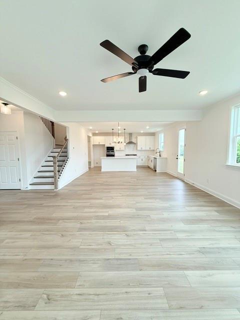 Open-concept living room and modern kitchen in The Hickory B floor plan at Wehunt Meadows, Hoschton, Georgia.