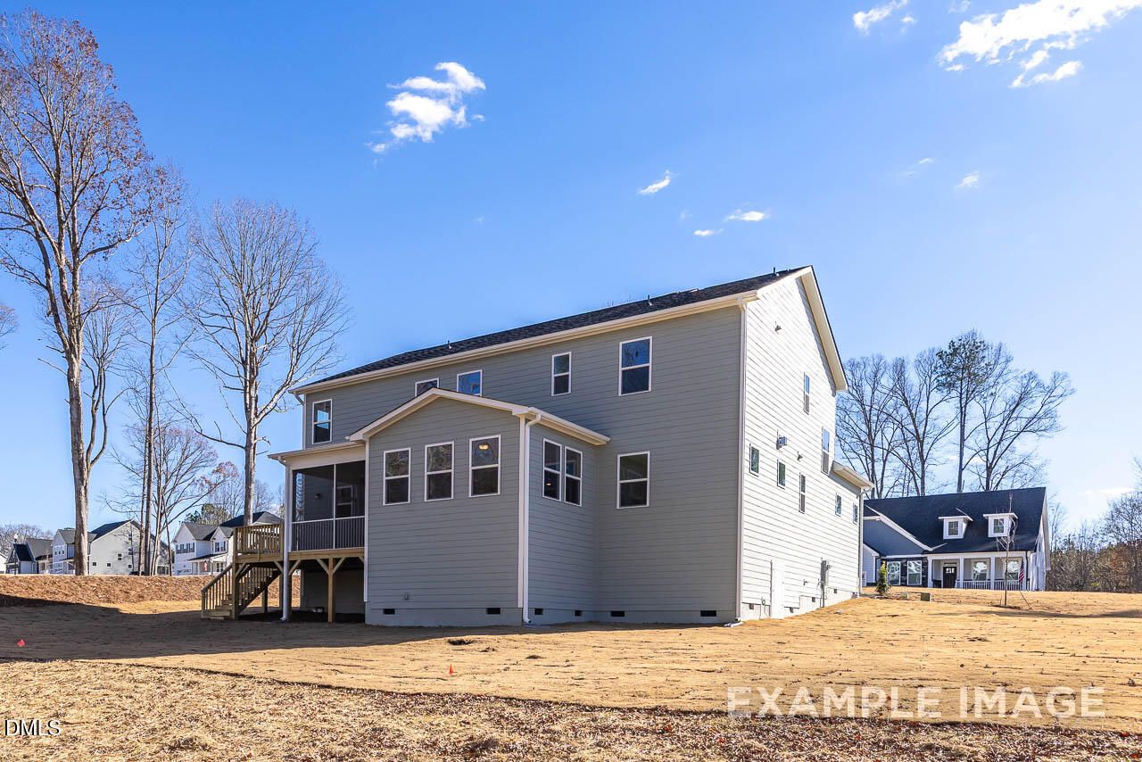 Back view of two-story Crawford D home by Davidson Homes with covered patio, deck, and screened porch in Tobacco Road, Angier, NC