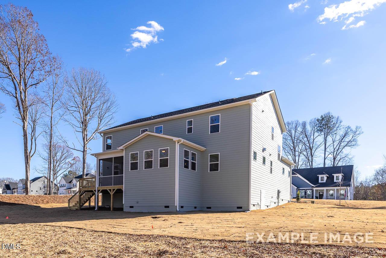 Back view of two-story Crawford D home by Davidson Homes with covered patio, deck, and screened porch in Tobacco Road, Angier, NC