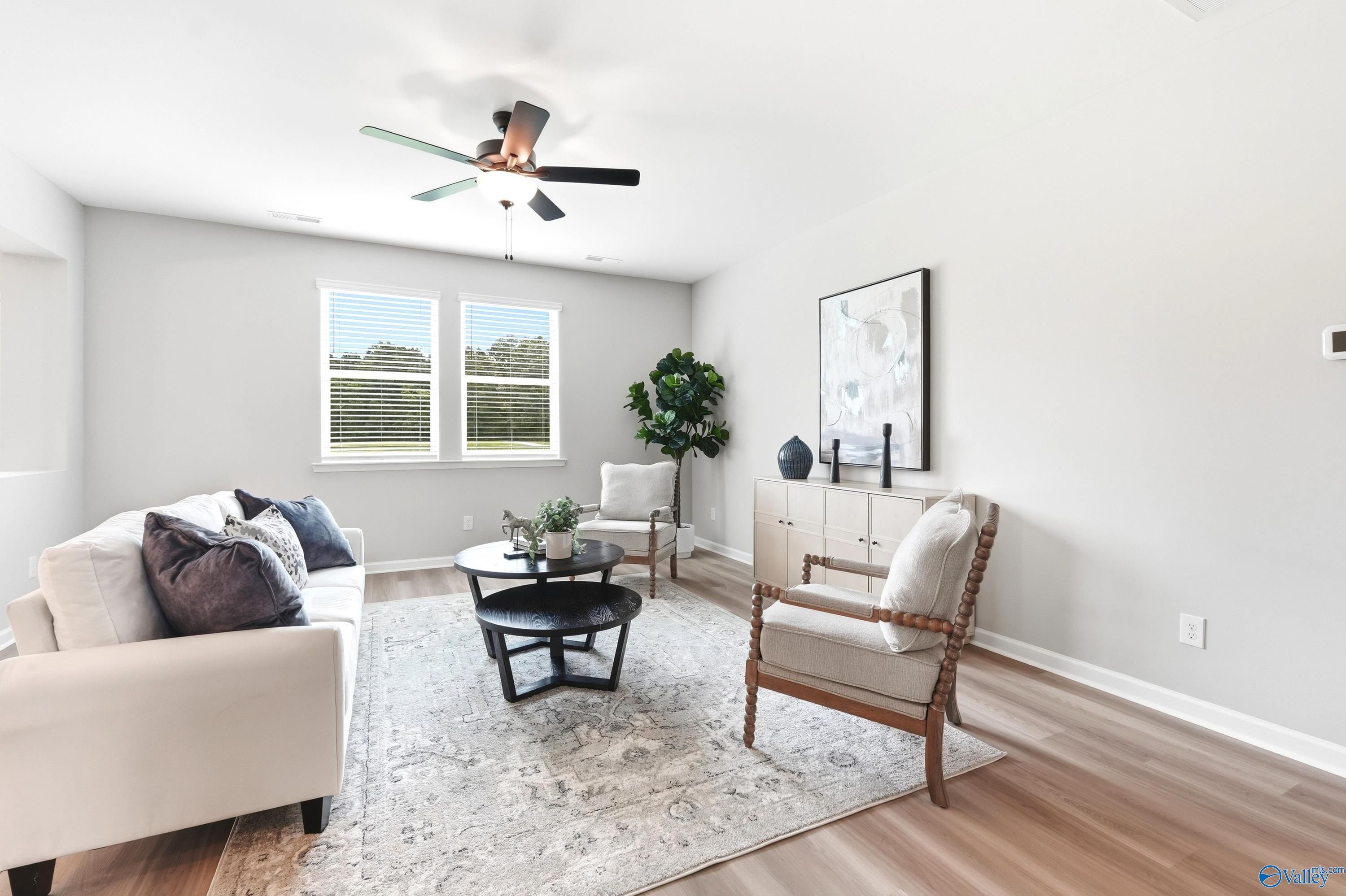 Bright living room with neutral decor in The Dorado floor plan by Davidson Homes at Riverton Preserve in Huntsville, Alabama.