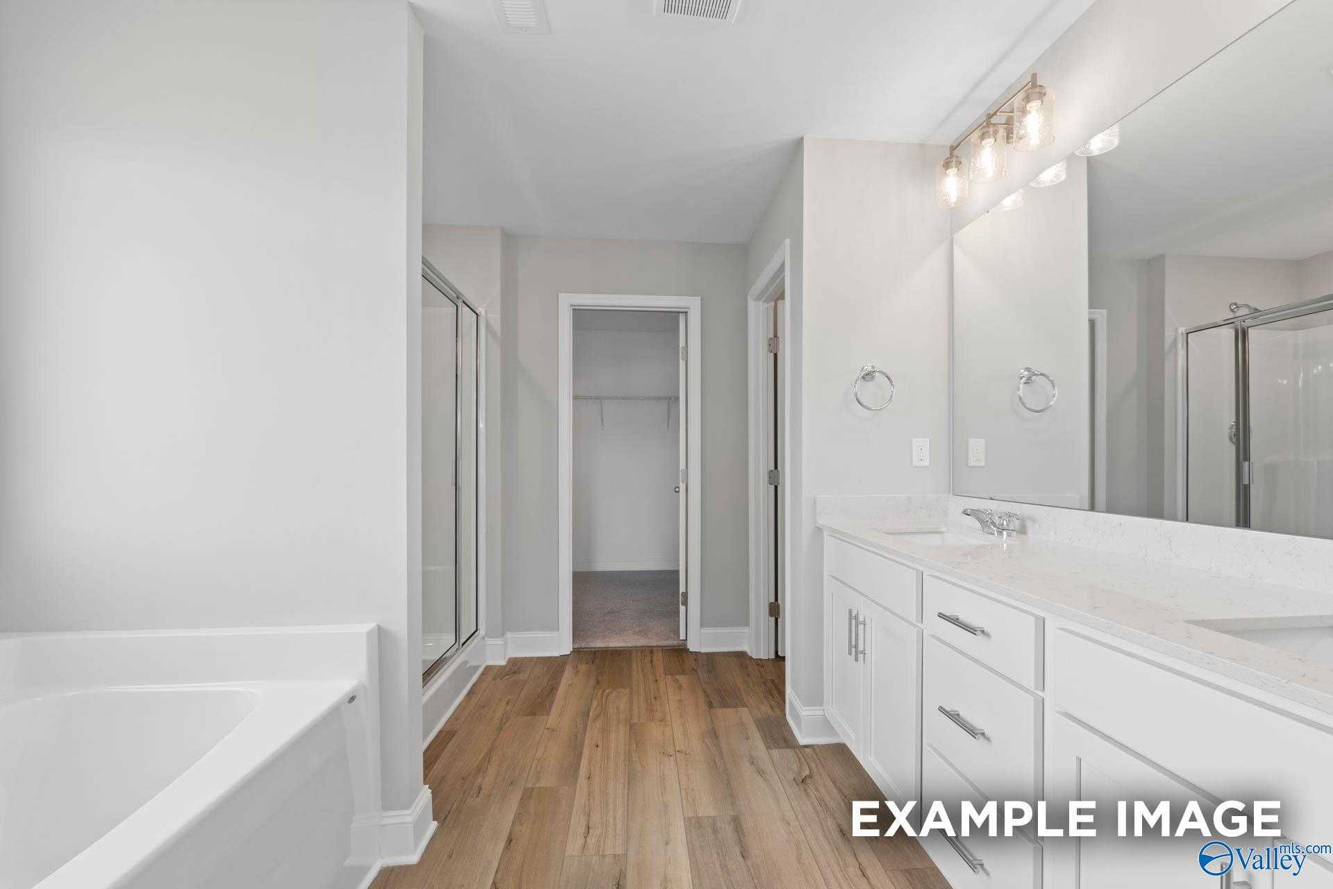 Elegant master bathroom with freestanding tub, double vanity, walk-in shower in Davidson Homes The Chelsea A, Athens AL