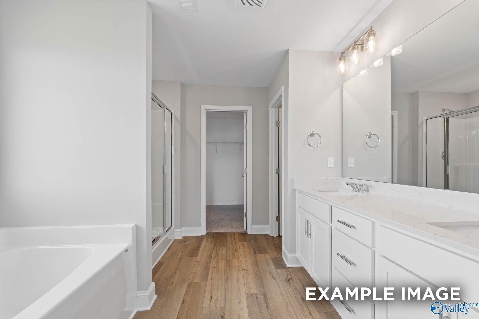 Elegant master bathroom with freestanding tub, double vanity, walk-in shower in Davidson Homes The Chelsea A, Athens AL