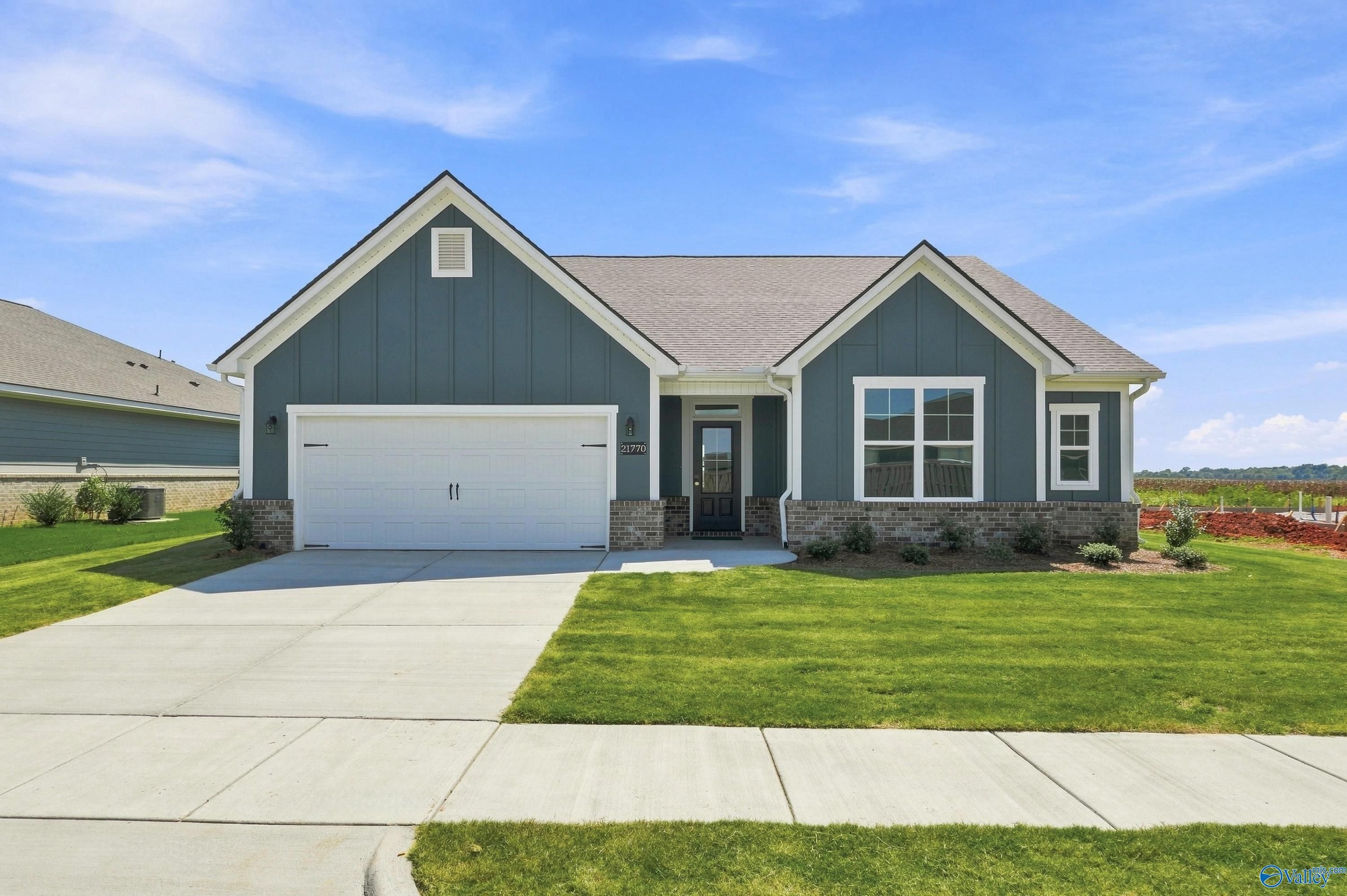 Blue-gray craftsman exterior with 2-car garage at The Montgomery D, a 3-bedroom Davidson Homes new construction in Athens, Alabama