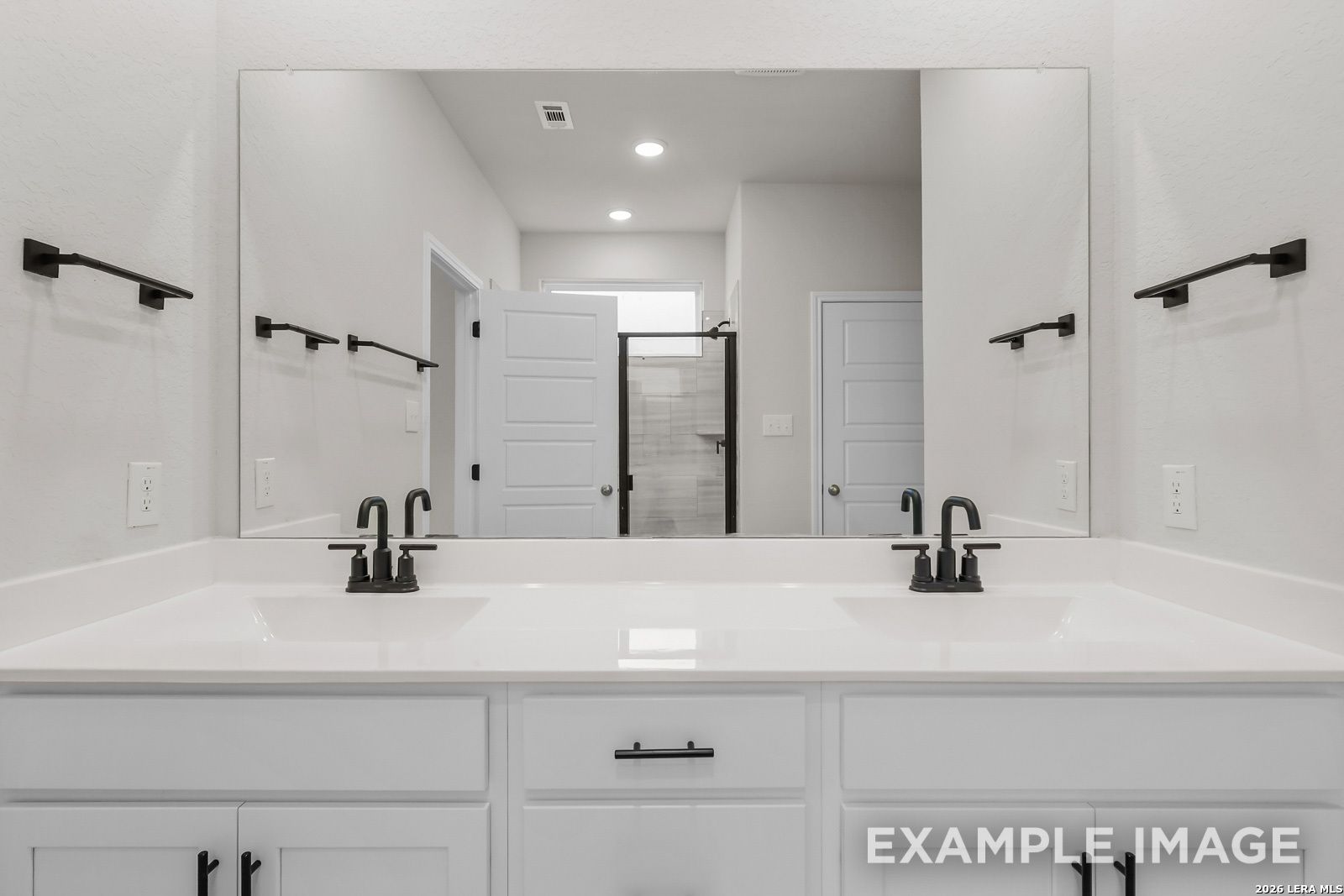 Modern double vanity with matte black fixtures in a Davidson Homes Sequoia C floor plan bathroom, Royal Crest, San Antonio.