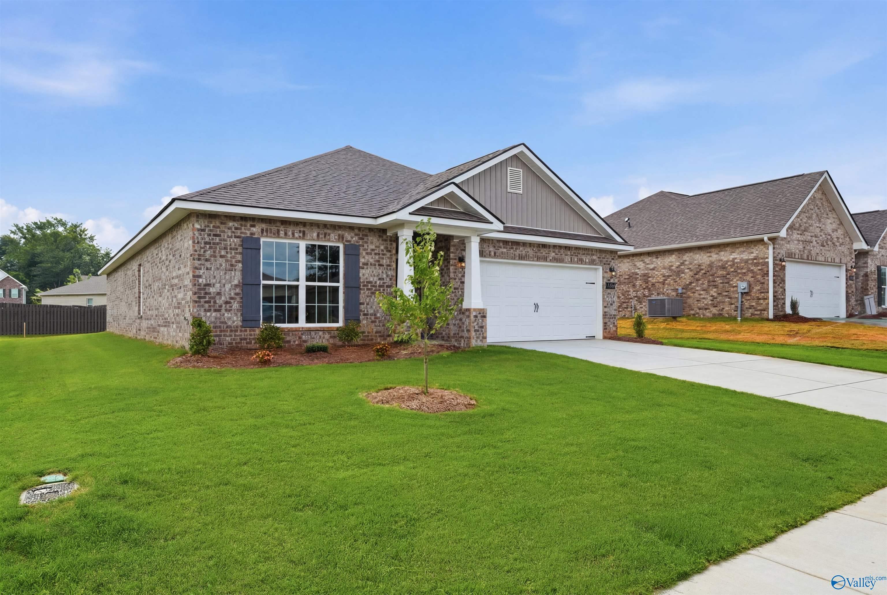 Brick exterior of The Daphne C floor plan by Davidson Homes in Flint Meadows, New Market, Alabama with 2-car garage.