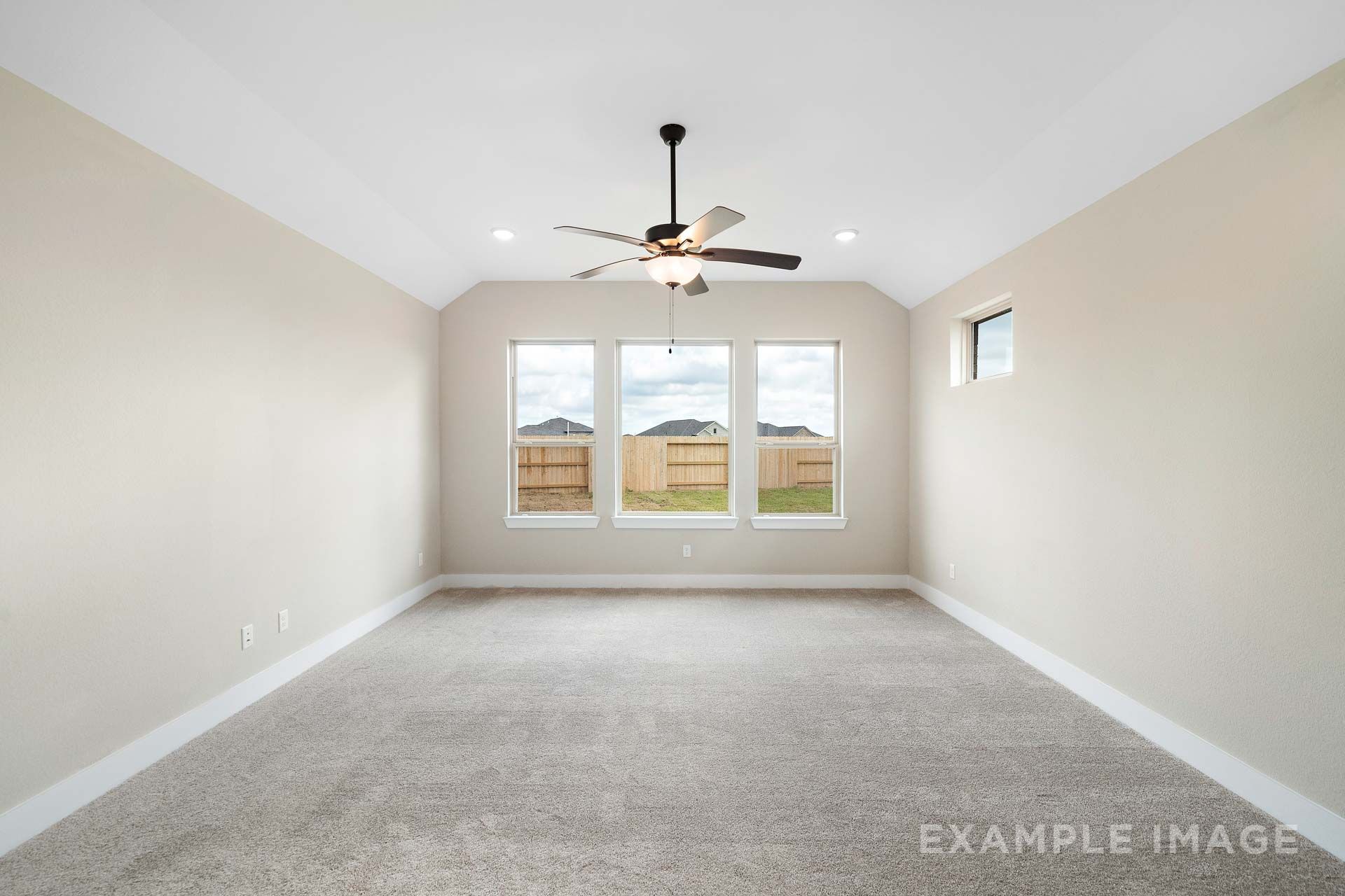 Spacious master suite in The Elizabeth by Davidson Homes, featuring vaulted ceiling, ceiling fan, and backyard-facing windows.