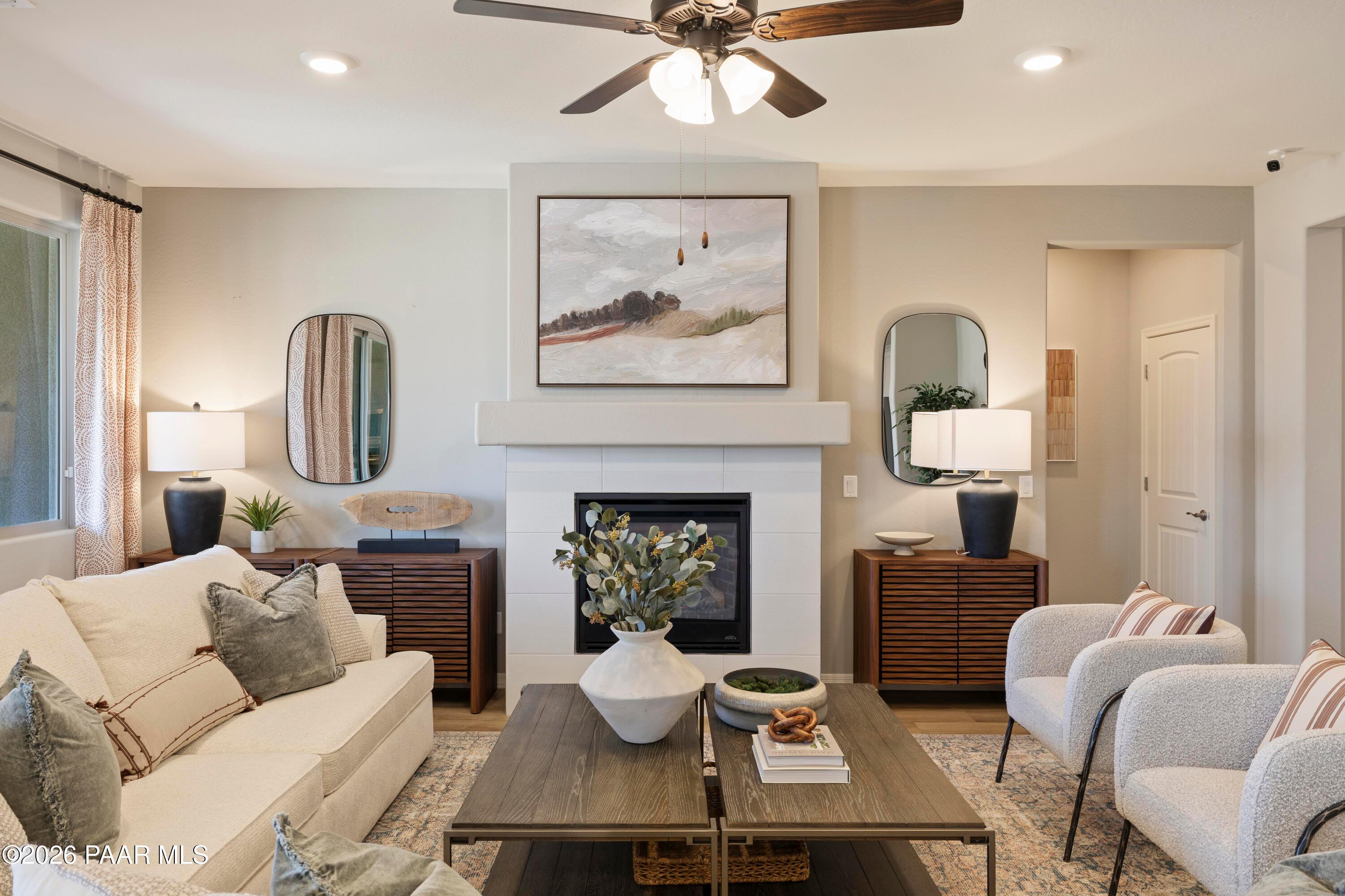 Modern living room with fireplace and neutral decor in The Harmony A floor plan at North Ridge, Prescott Valley, Arizona.