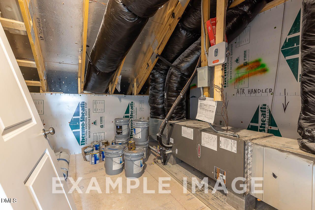 HVAC air handler and insulated flex ductwork in attic mechanical space of new Davidson Homes Ash C floor plan in Lillington, NC