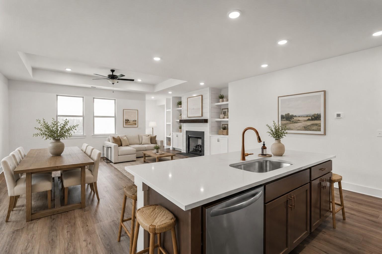 Open-concept kitchen and living area with fireplace in The Prairie C floor plan at Woods Crossing, Gallatin, Tennessee.