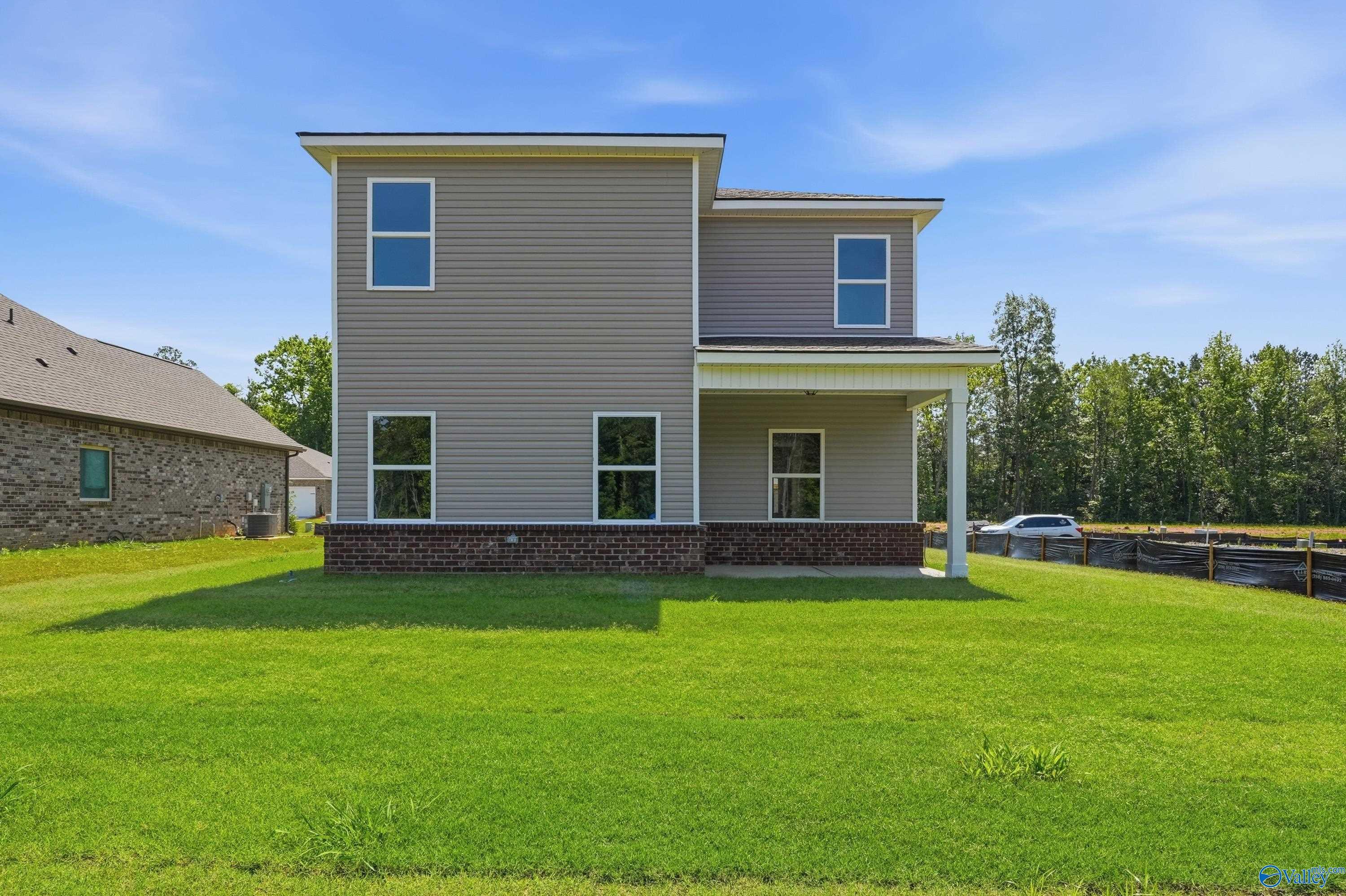 Rear exterior view of The Russell A floor plan by Davidson Homes in Spragins Cove, Huntsville, Alabama with large backyard.