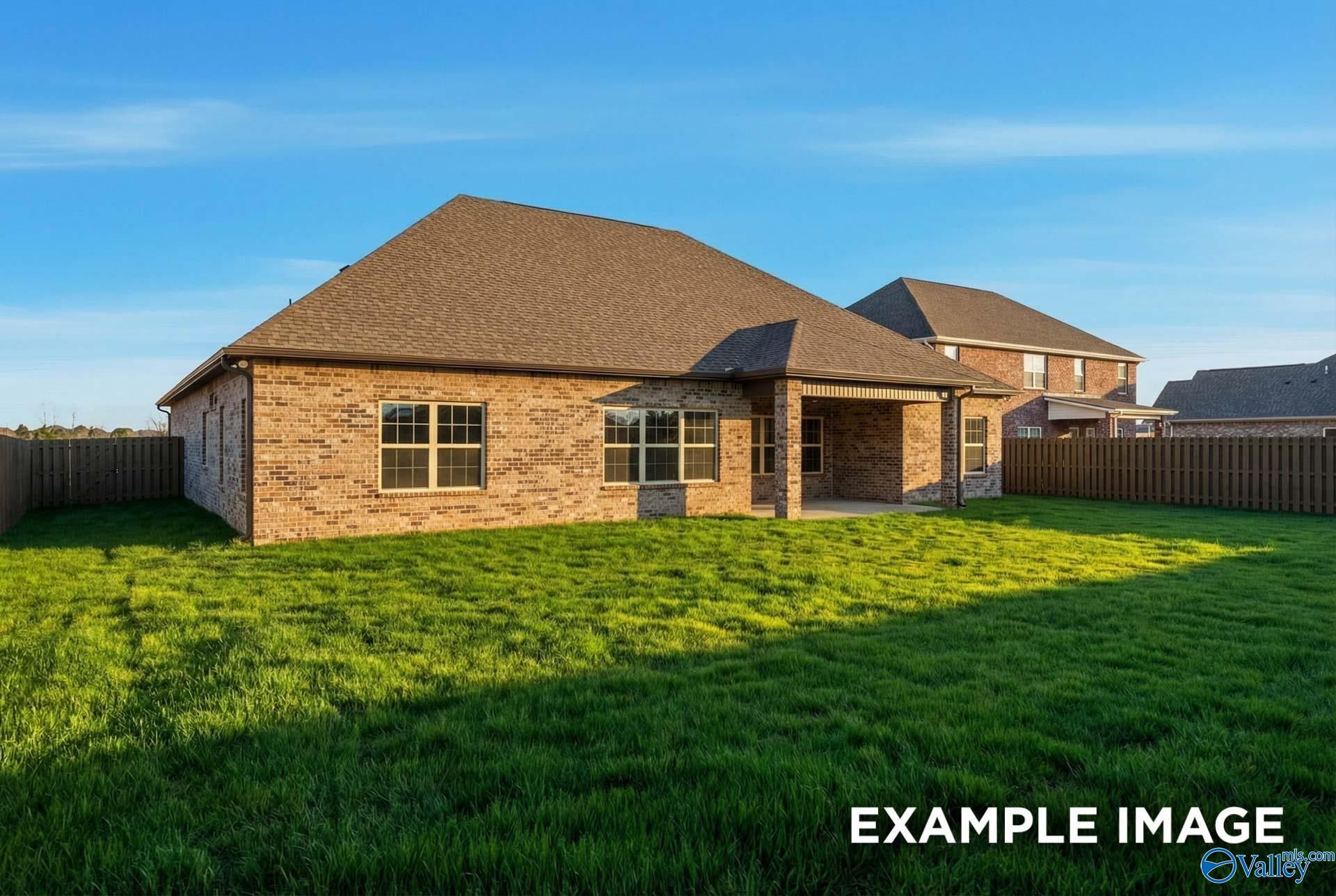 Brick 1.5-story Finleigh home with covered porch, fenced green backyard in Hollon Meadow, Decatur, Alabama
