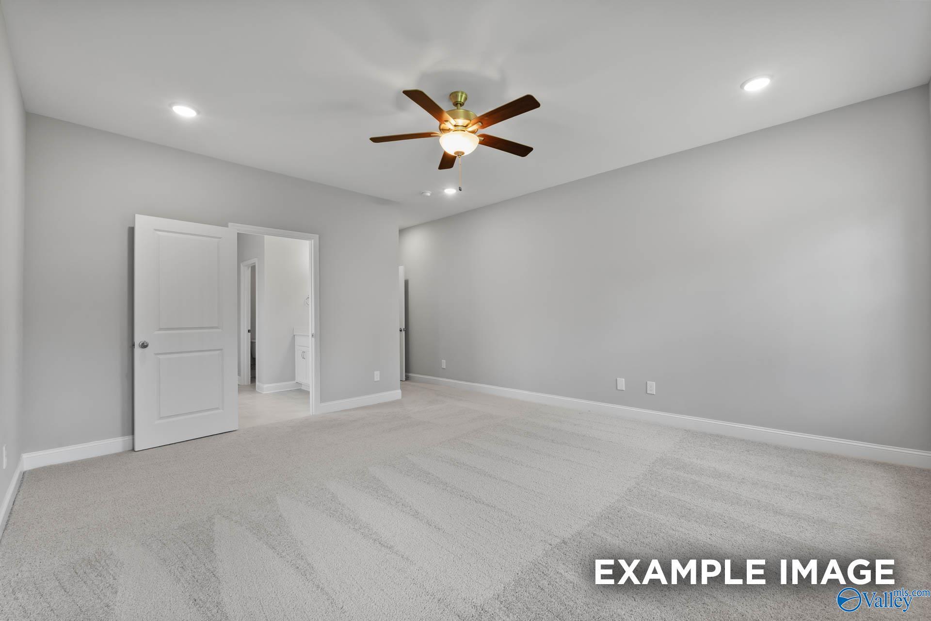 Spacious bonus room with gray walls, beige carpet, ceiling fan, recessed lights, and open double doors in Davidson Homes The Rockford with Bonus, Madison, Alabama