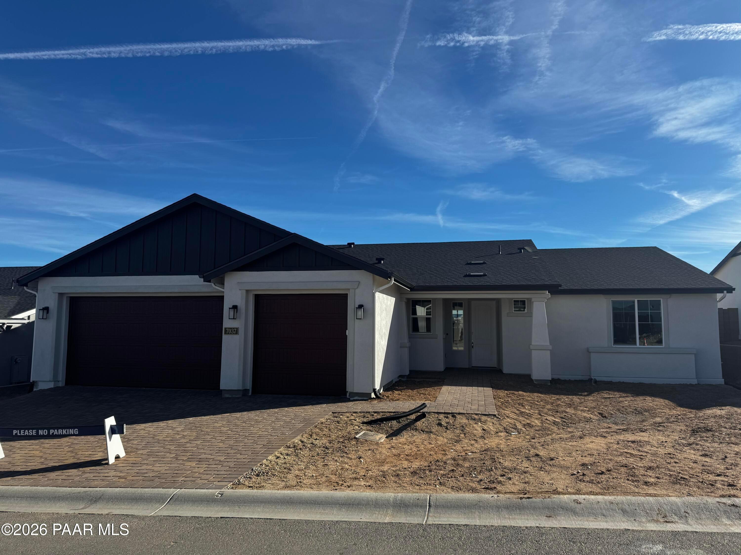 Modern single-story 3-bedroom home with 3-car garage, black roof, and stucco exterior in Westwood, Prescott, Arizona