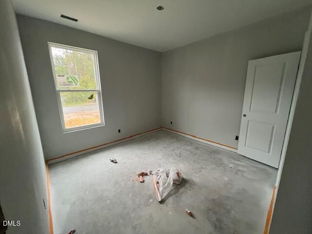 Unfinished bedroom with window and white door in new construction Davidson Homes Daphne C plan, Wellers Knoll, Lillington NC