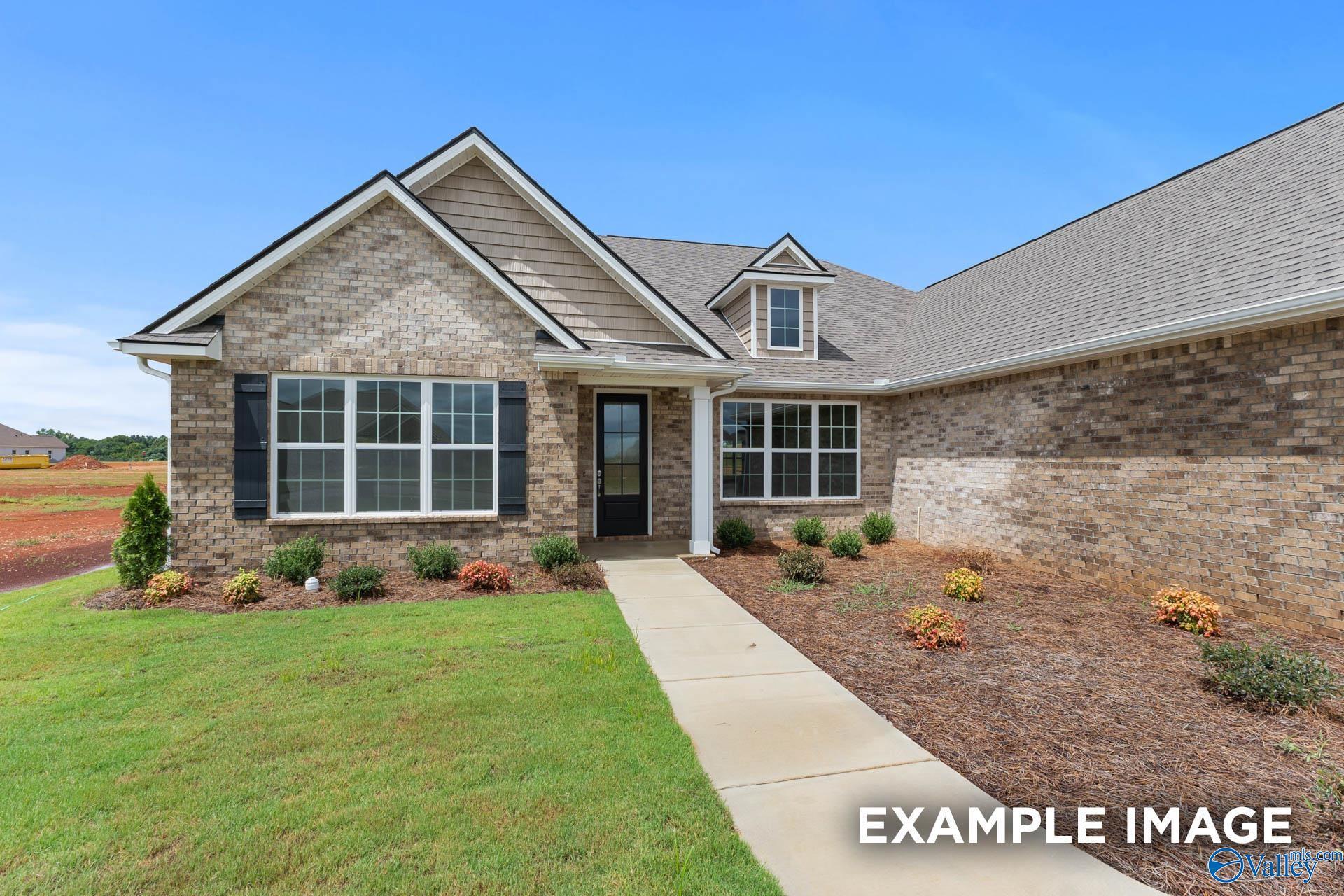 Modern 2-story brick home exterior with gabled roof, large windows, and 3-car garage in Toney, Alabama - Davidson Homes Emory