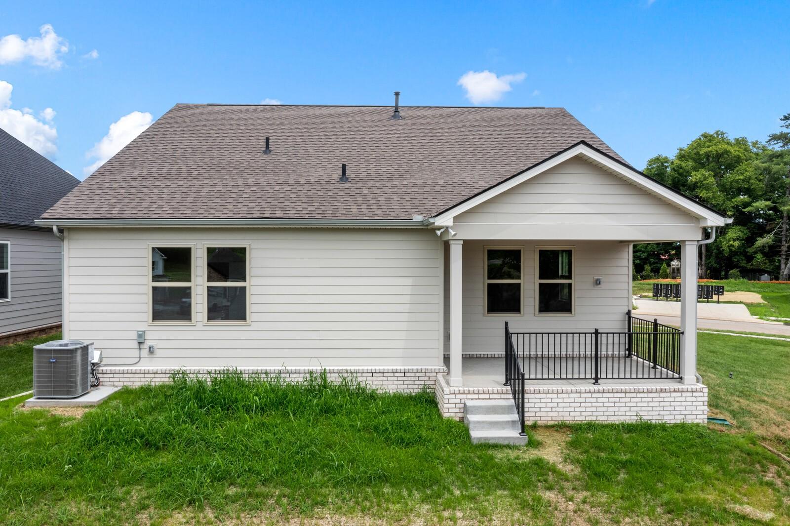 Rear exterior view of The Prairie C floor plan with covered patio in Woods Crossing, Gallatin, Tennessee.