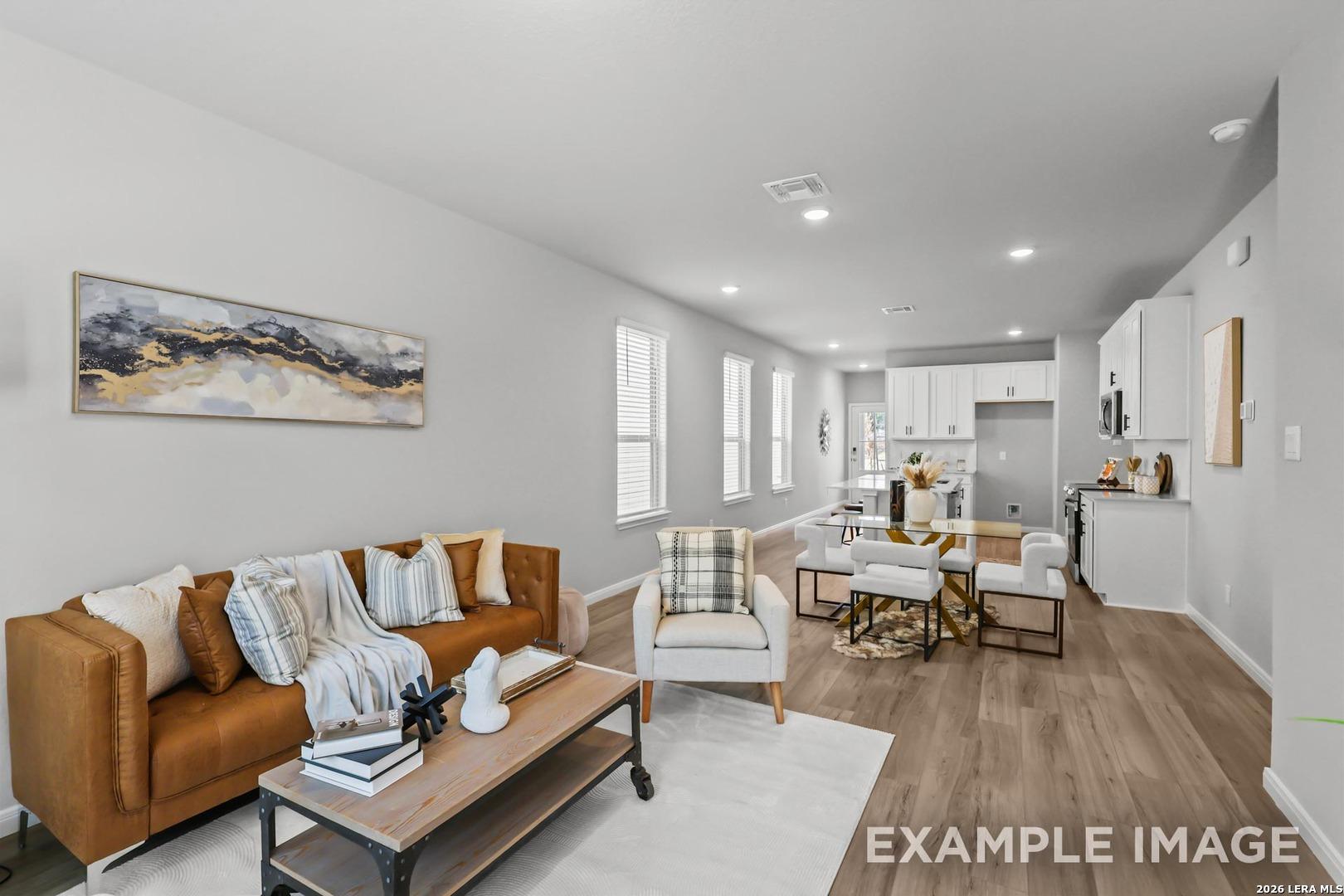 Open-concept living room and dining area in The Gillian A floor plan by Davidson Homes in Cedar Heights, San Antonio.