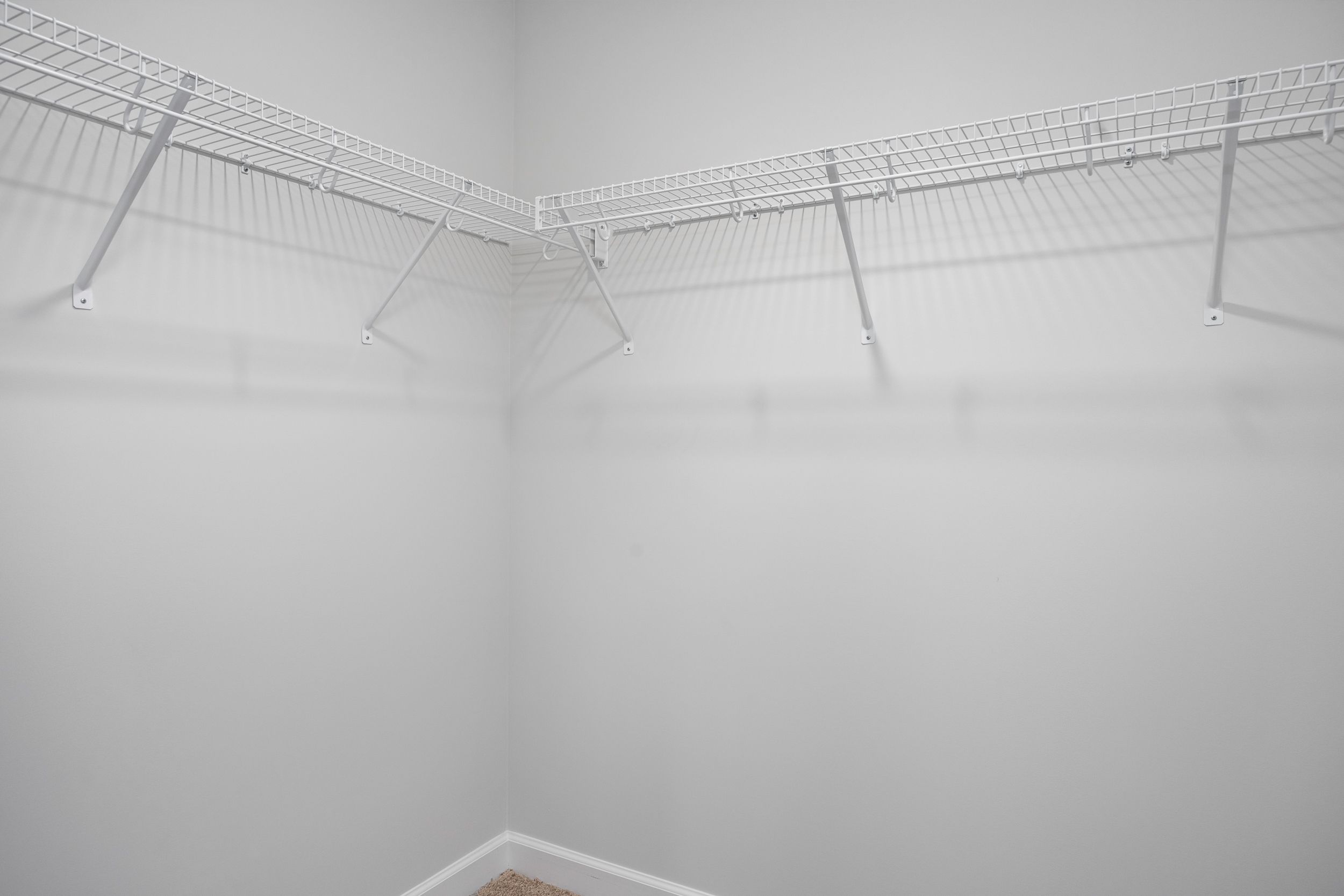 Spacious walk-in closet with white wire shelving in the master suite of The Durham by Davidson Homes.