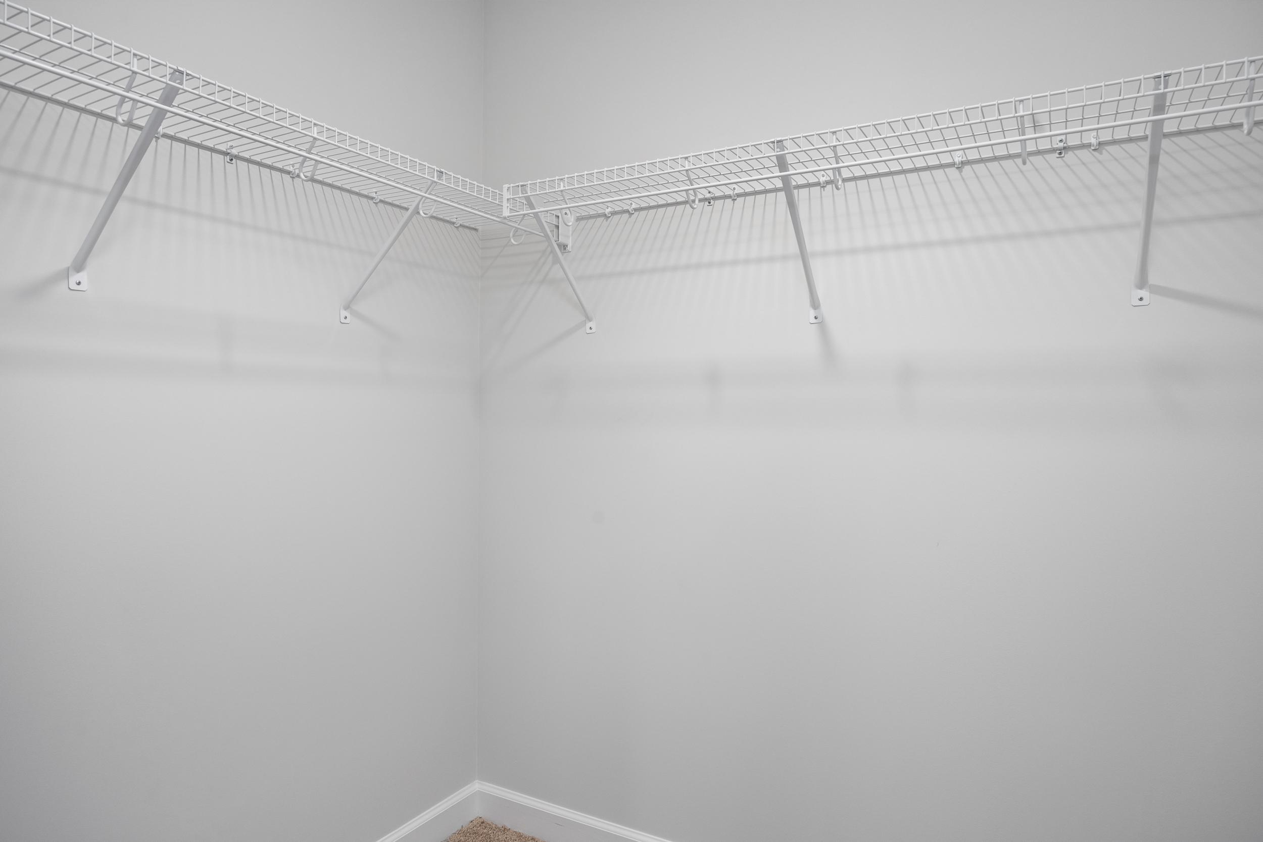 Spacious walk-in closet with white wire shelving in the master suite of The Durham by Davidson Homes.