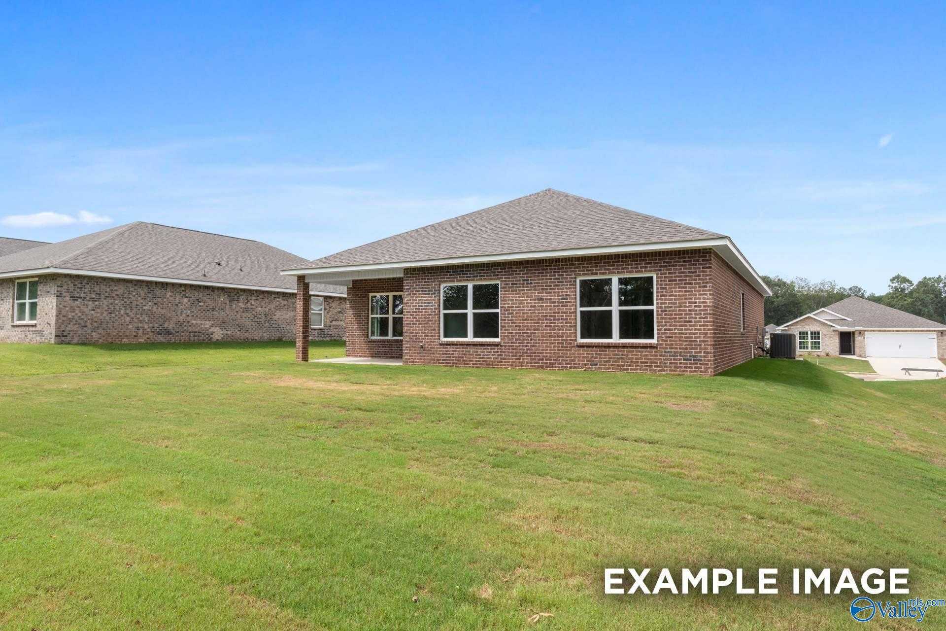 Single-story brick home with covered porch, large windows, and 2-car garage on green lot in Lynn Meadows, Meridianville, Alabama - Davidson Homes The Franklin