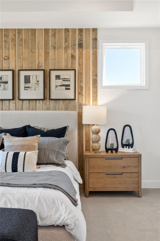 Modern bedroom with wood slat accent wall and cozy bedding in The Aspen C floor plan by Davidson Homes in Buford, GA.