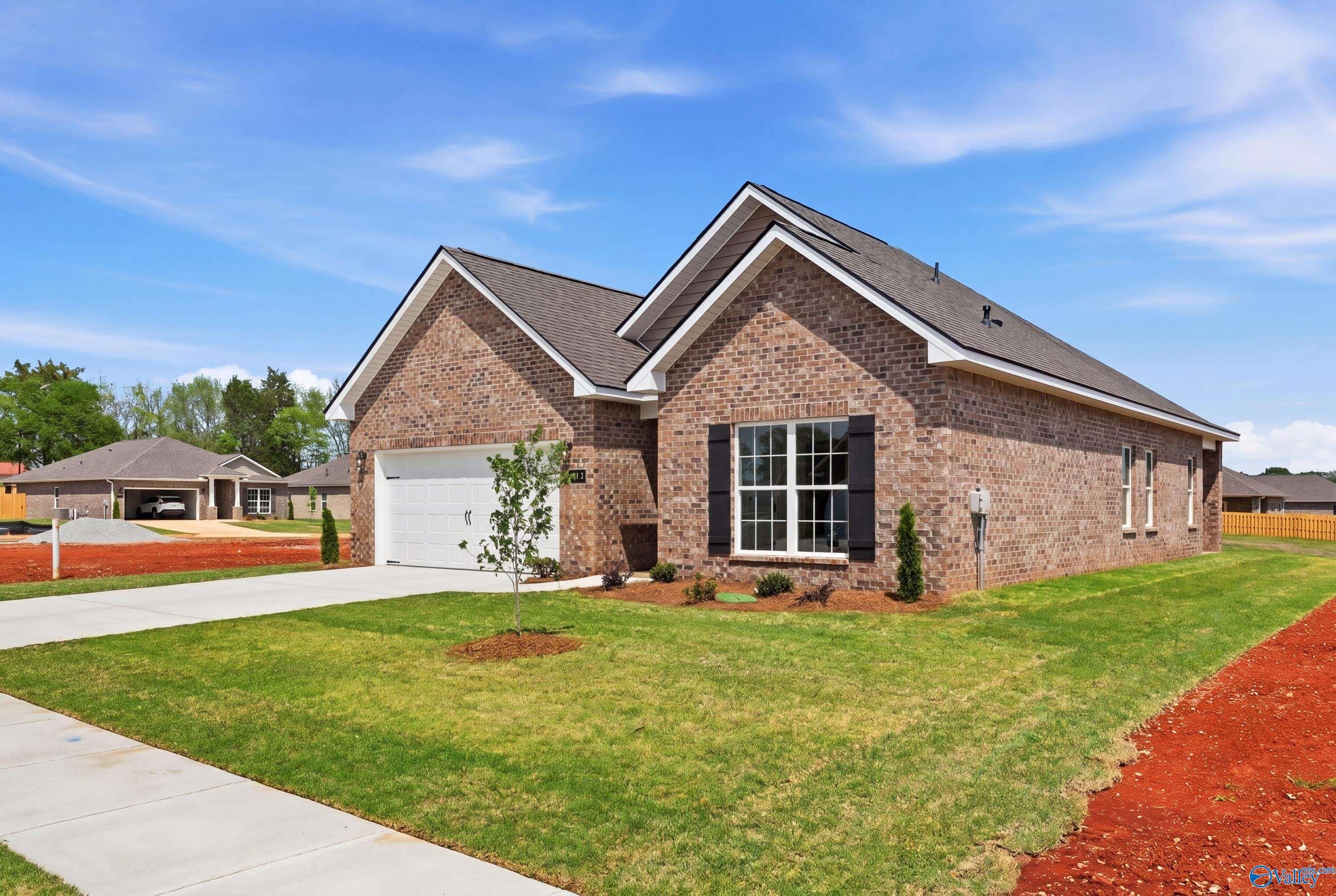 Brick single-story home with gabled roof, 2-car garage, and landscaped yard in Lynn Meadows, Meridianville, Alabama
