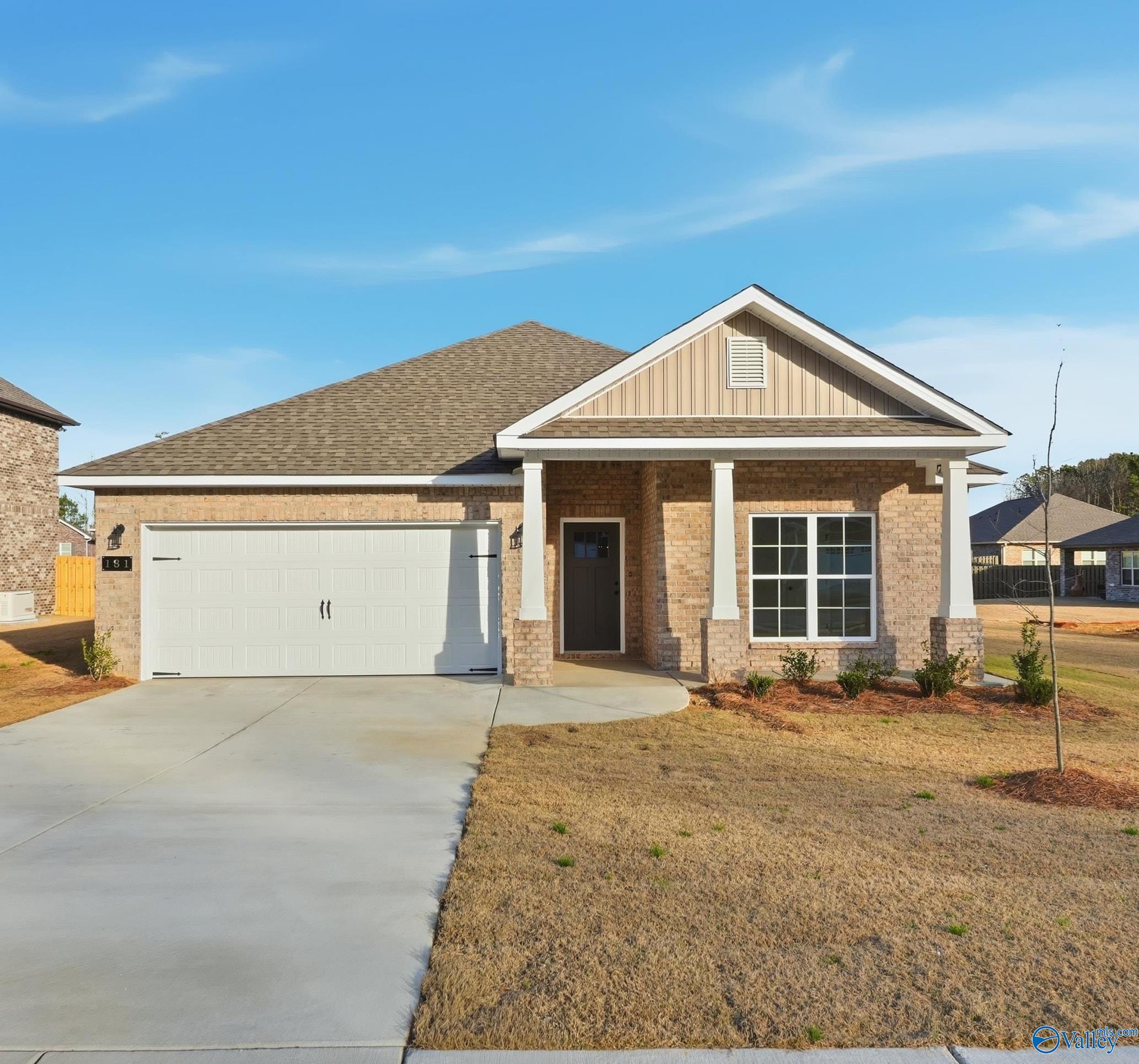 Davidson Homes The Daphne D 4-bedroom brick ranch exterior with columned porch, 2-car garage, and driveway in The Highlands, Arab, Alabama