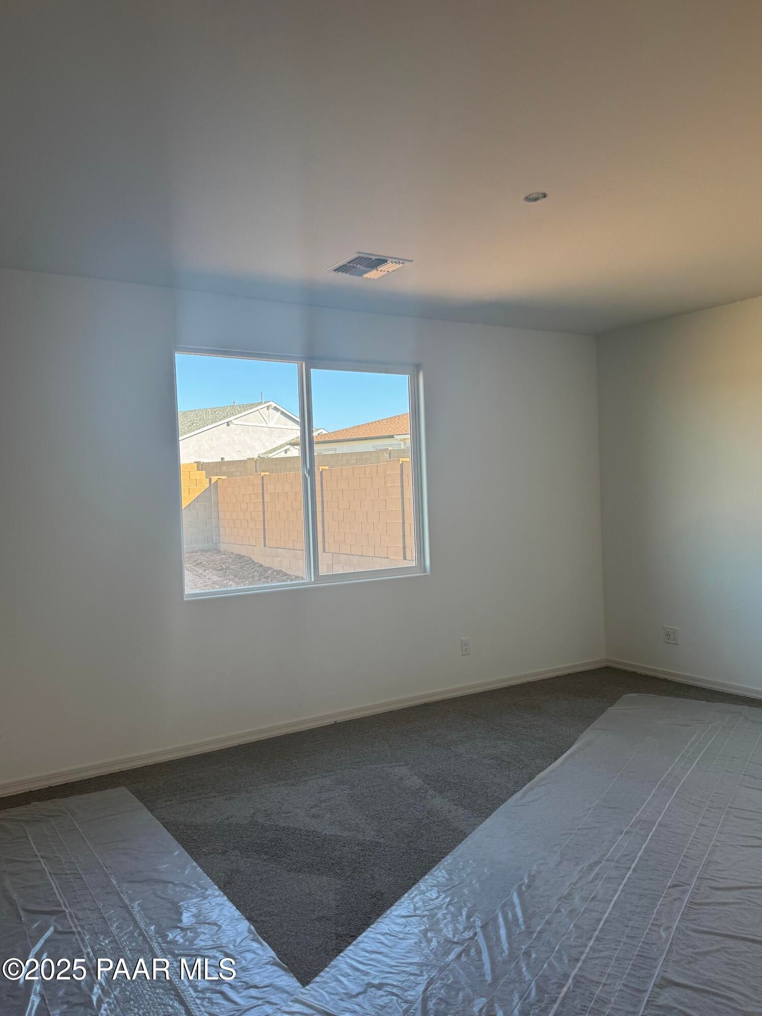 Bright empty bedroom with large window overlooking Westwood neighborhood in Prescott Arizona, The Summit A by Davidson Homes