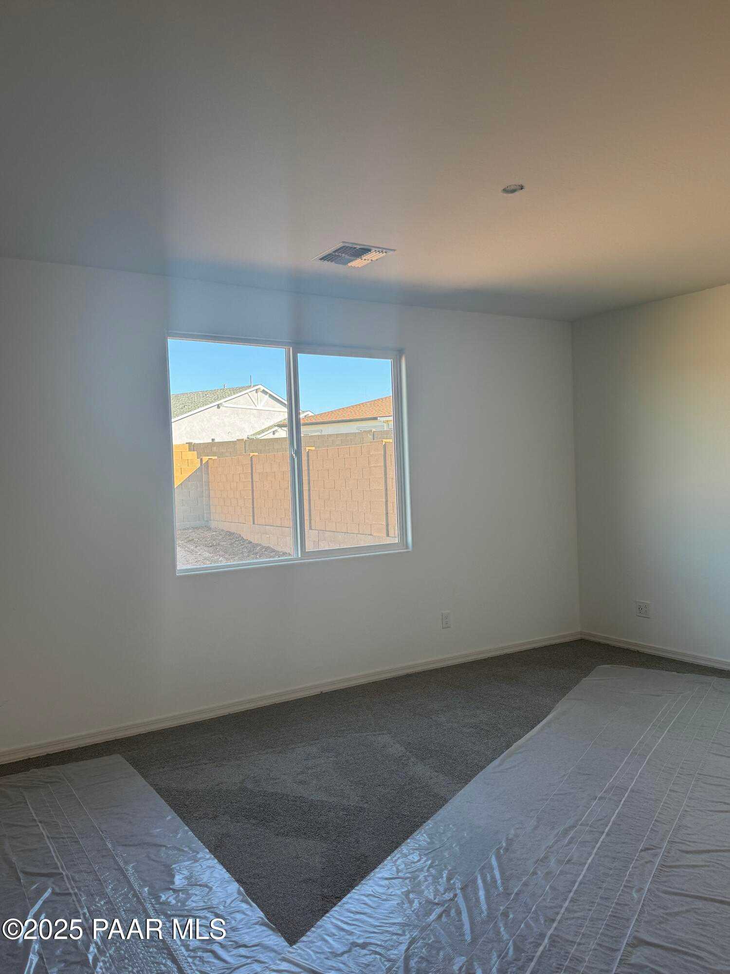 Bright empty bedroom with large window overlooking Westwood neighborhood in Prescott Arizona, The Summit A by Davidson Homes