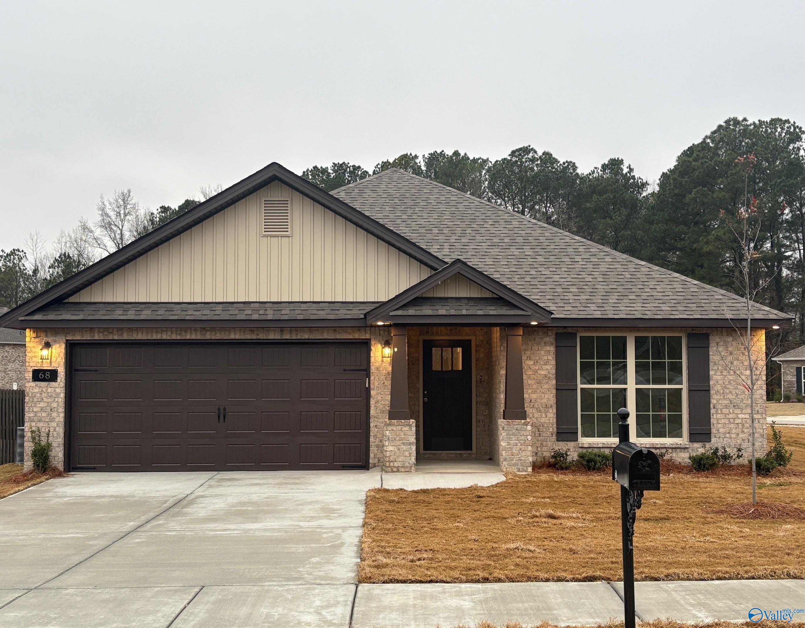 Single-story 4-bedroom home with 2-car garage, tan brick and siding exterior, front entry in The Highlands, Arab, Alabama by Davidson Homes The Daphne C