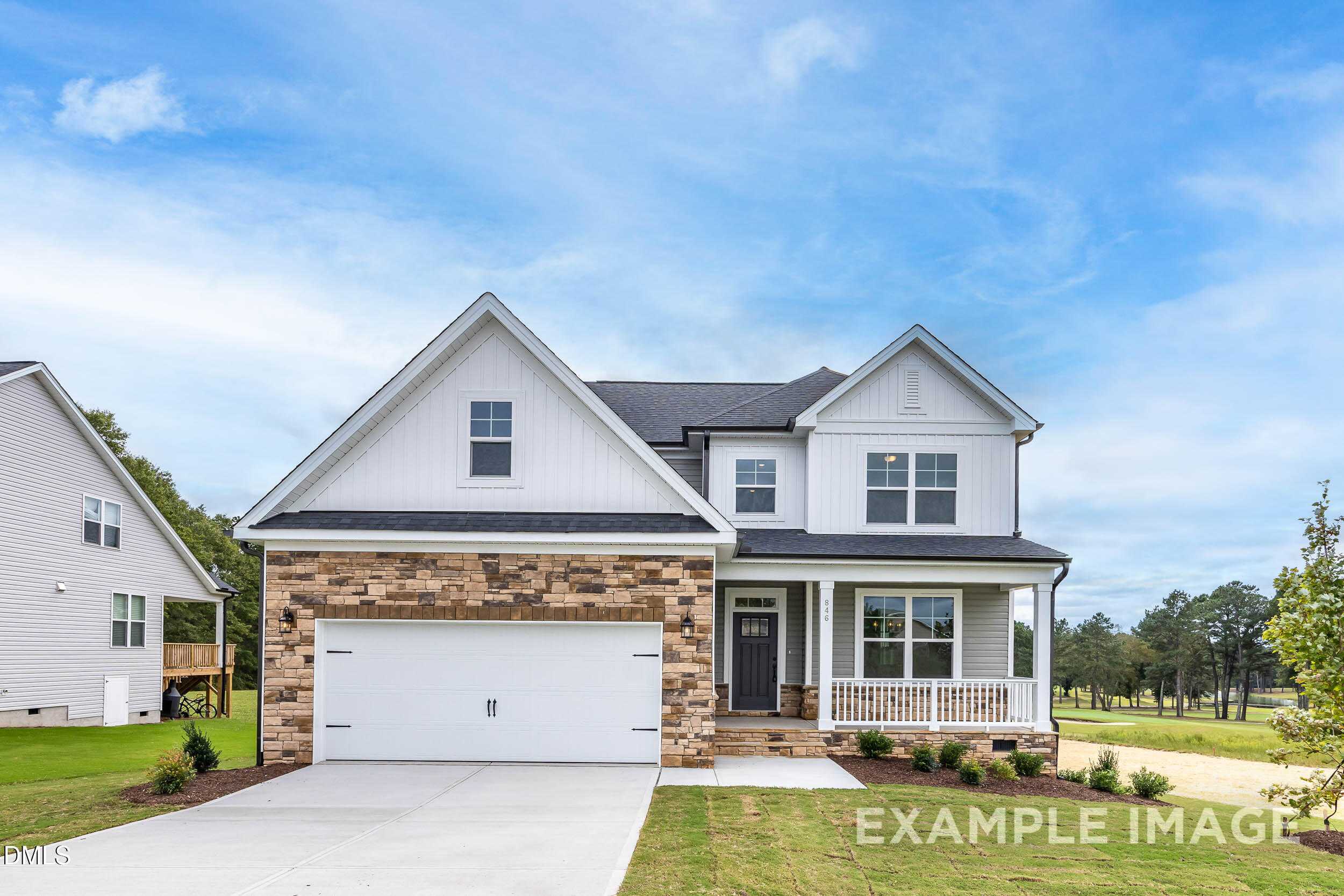Two-story Davidson Homes The Ash B exterior with white siding, brick accents, covered porch, 2-car garage in Retreat at North Main, Lillington, NC