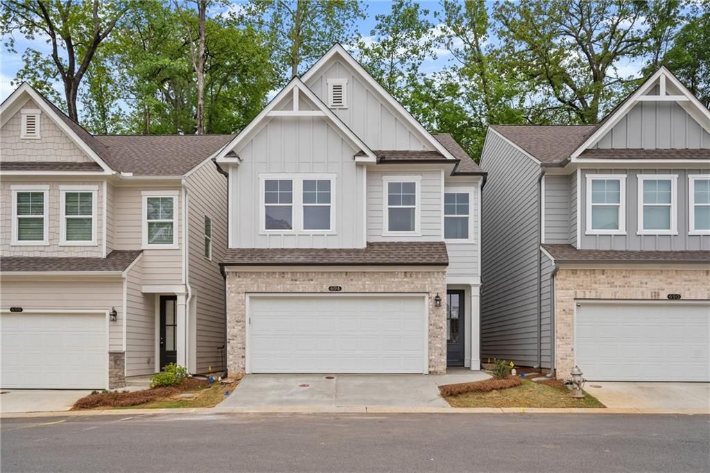 Three contemporary two-story homes with two-car garages and brick facades in The Village at Shallowford, Kennesaw, Georgia by Davidson Homes