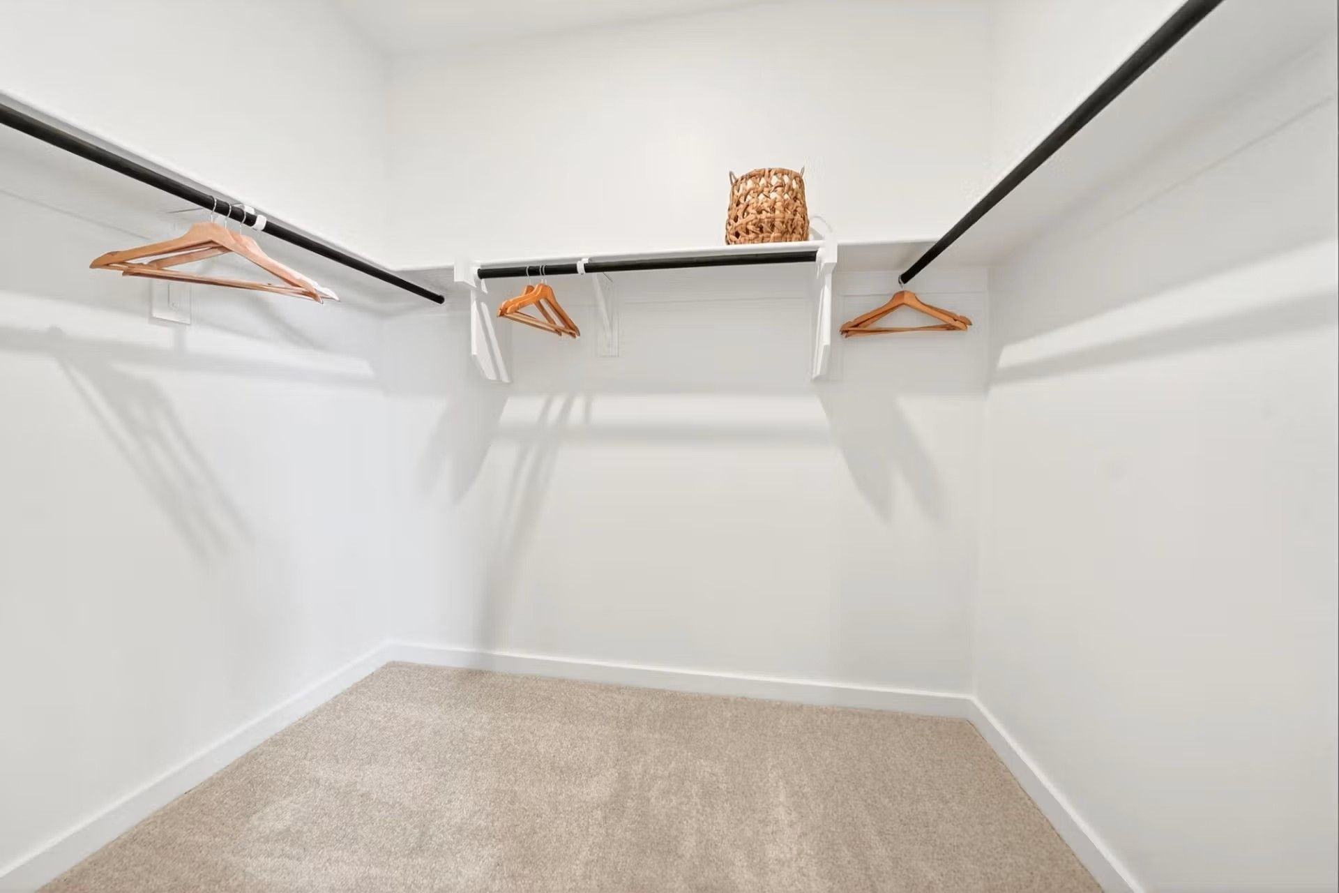 Walk-in closet with shelving and rods in The Laurel I floor plan by Davidson Homes in Heartland, Texas.