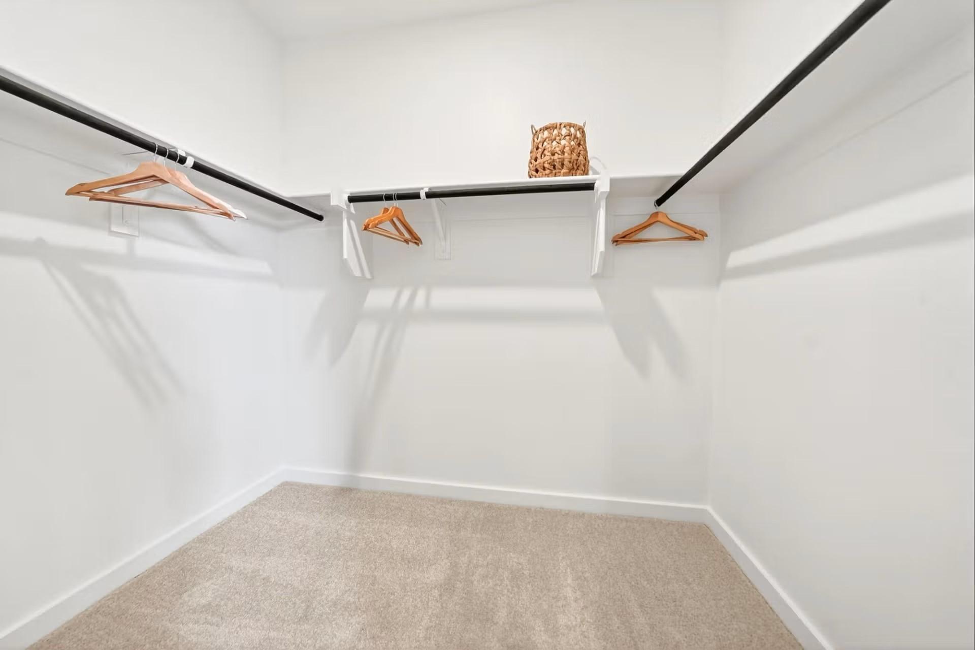 Walk-in closet with shelving and rods in The Laurel I floor plan by Davidson Homes in Heartland, Texas.
