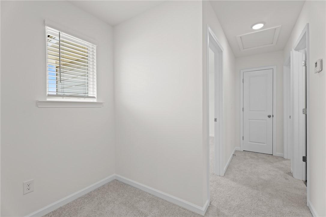 Bright hallway and landing area with neutral carpet in The Stella D floor plan by Evermore Homes, Silver Oak, Cusseta, AL.
