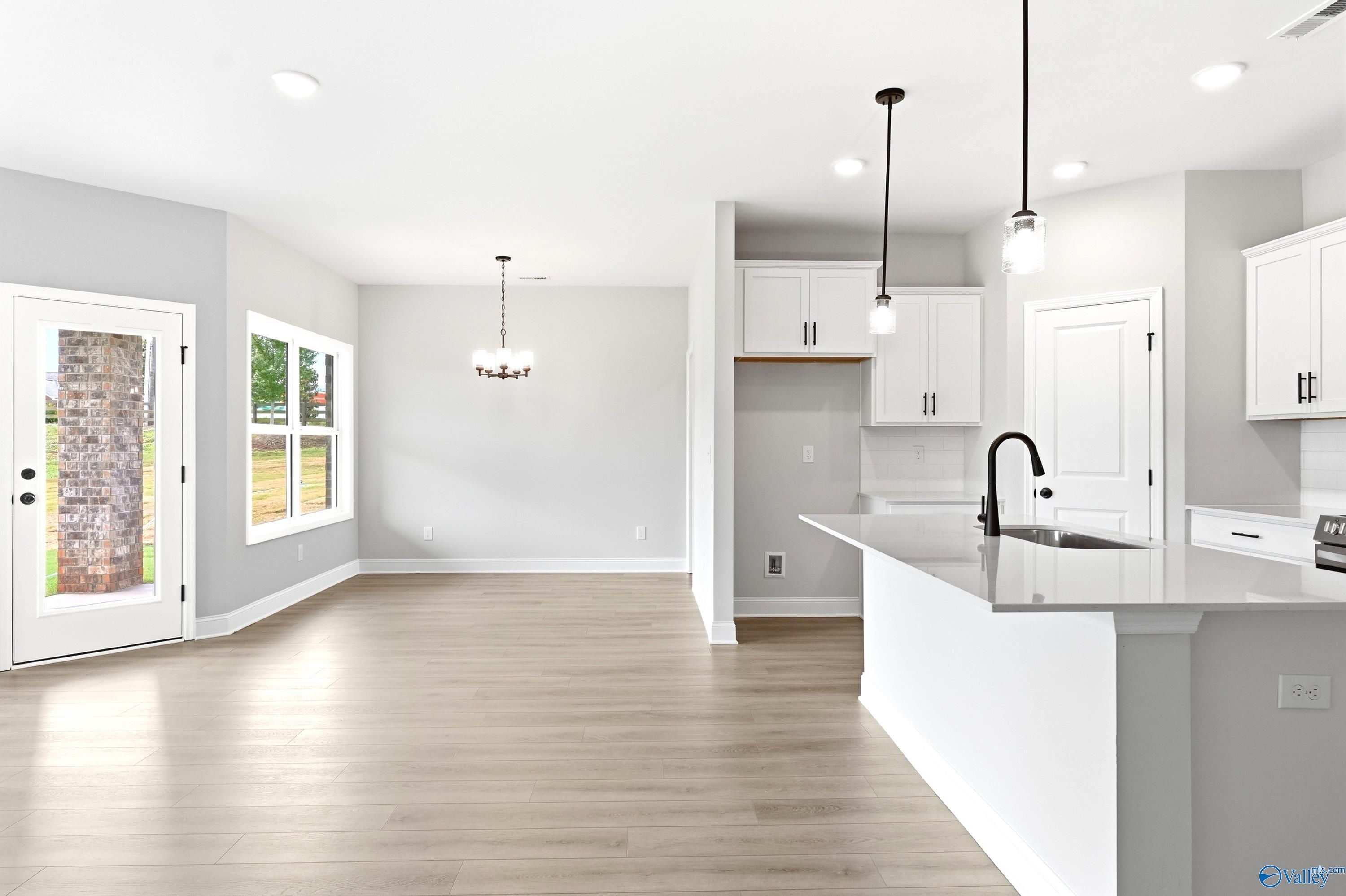 Open-concept kitchen and dining area in The Daphne C floor plan at Flint Meadows, New Market, Alabama.